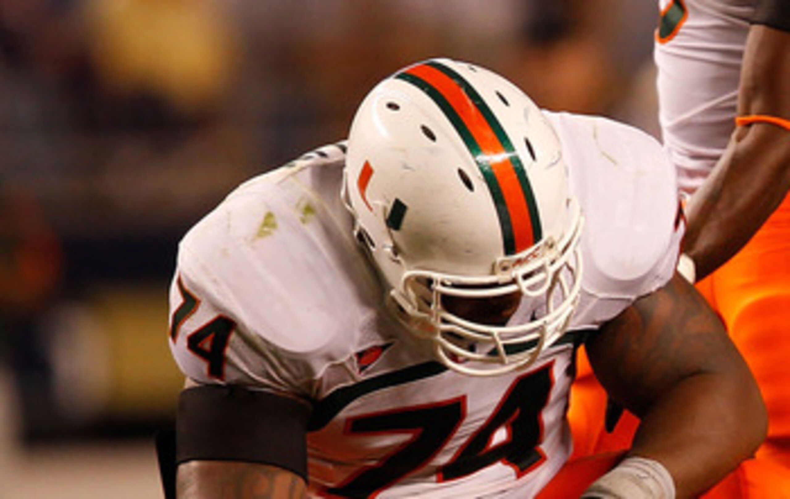 PITTSBURGH - SEPTEMBER 23:  Jacory Harris #12 of the Miami Hurricanes lays on the ground as teammate Orlando Franklin #74 looks on after being sacked by the Pittsburgh Panthers on September 23, 2010 at Heinz Field in Pittsburgh, Pennsylvania.  (Photo by J
