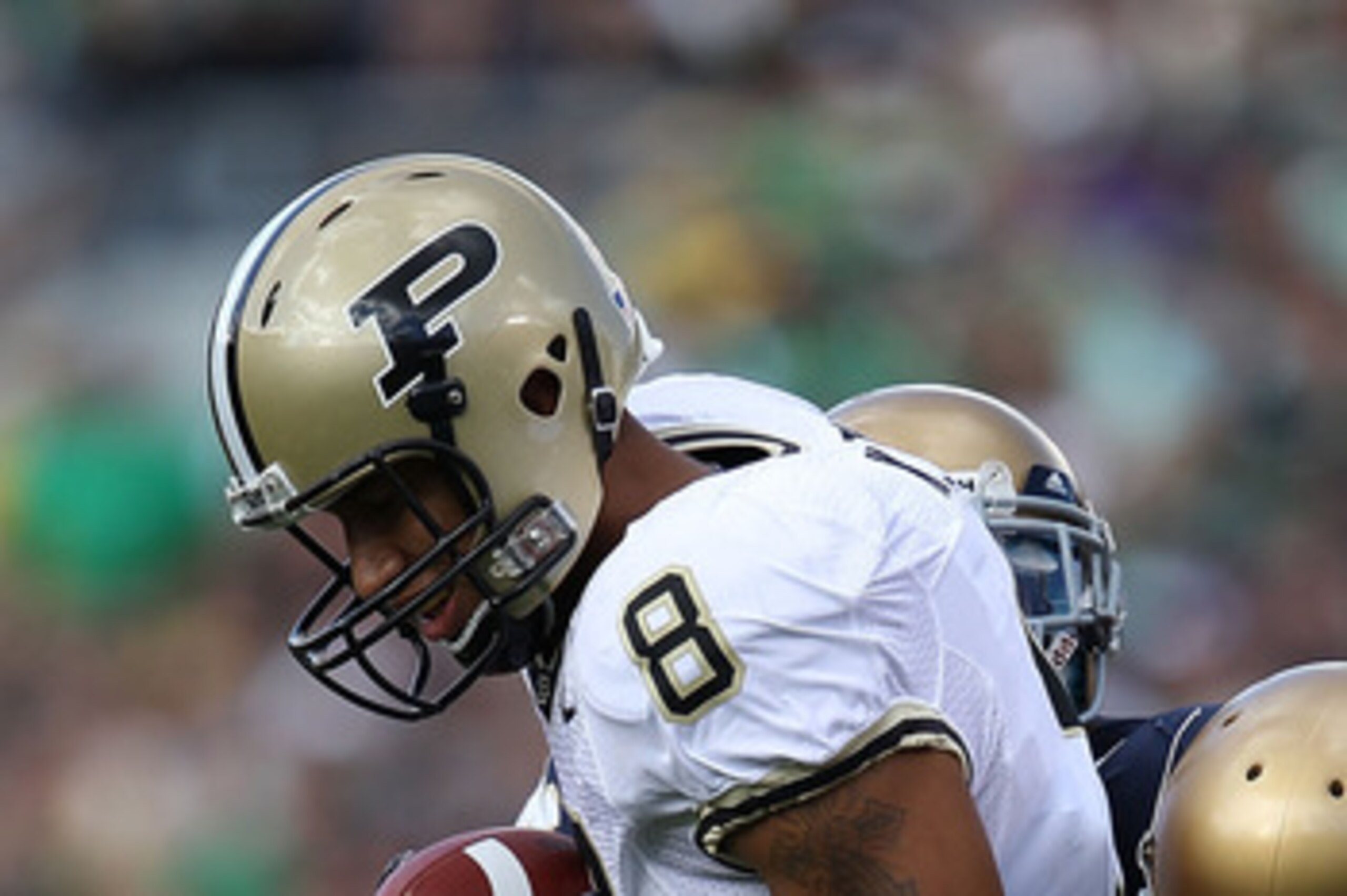 SOUTH BEND, IN - SEPTEMBER 04: Keith Smith #8 of the Purdue Boilermakers is stopped by Darrin Walls #2 (R) and Jamoris Slaughter #26 of the Notre Dame Fighting Irish at Notre Dame Stadium on September 4, 2010 in South Bend, Indiana. Notre Dame defeated Pu
