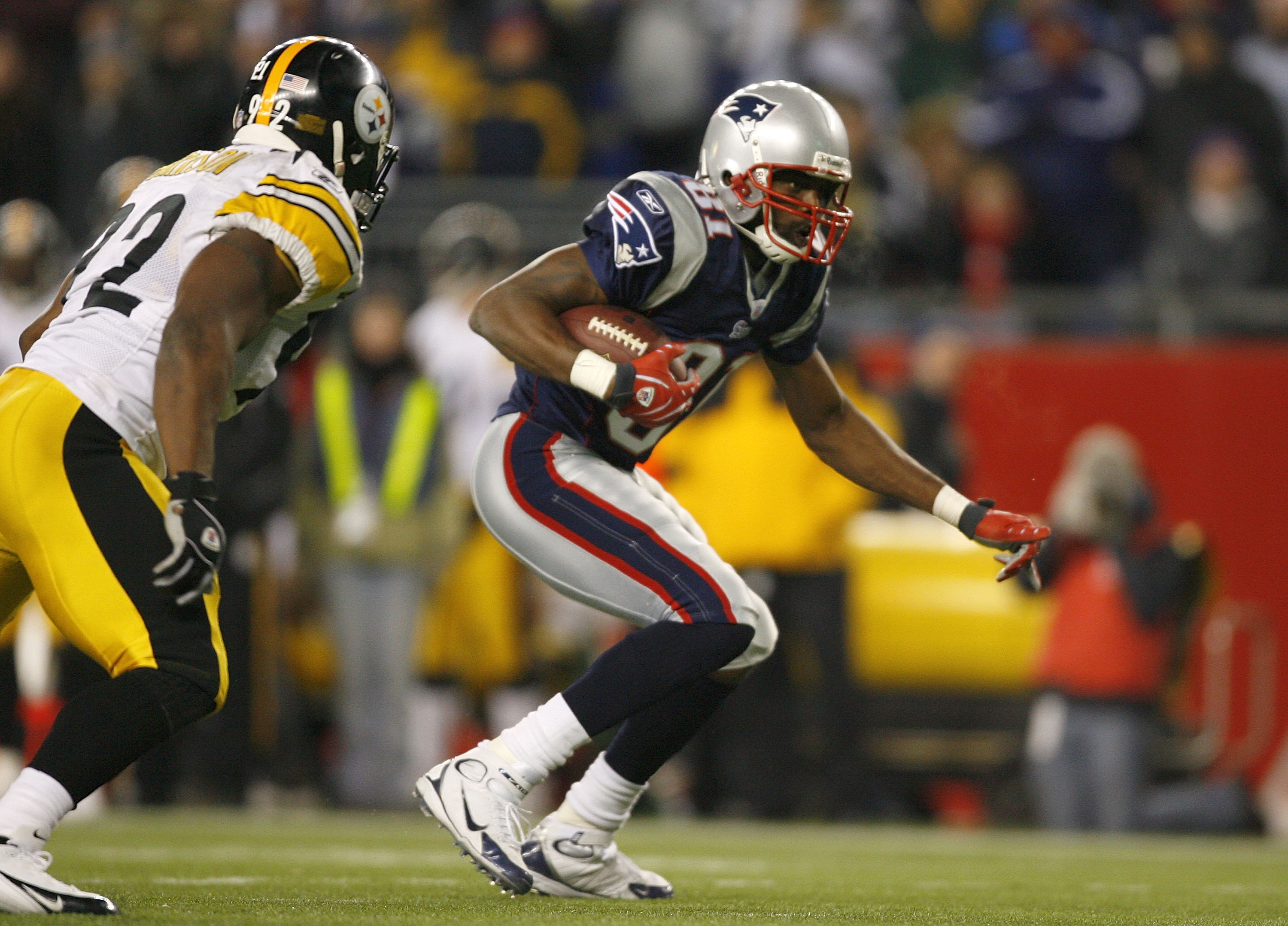 FOXBORO, MA - DECEMBER 9:   Randy Moss #81 of the New England Patriots gains yards against James Harrison #92 of the Pittsburgh Steelers after a penalty was called in the third quarter at Gillette Stadium December 9, 2007 in Foxboro, Massachusetts. The Pa