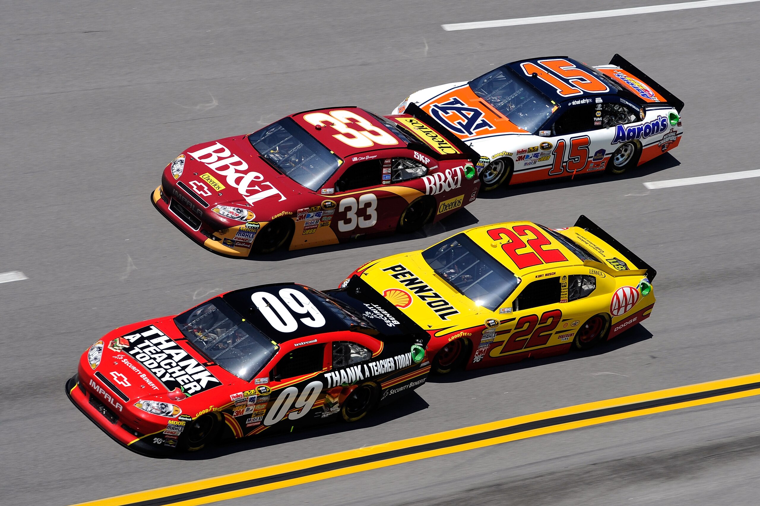TALLADEGA, AL - APRIL 17: Clint Bowyer, driver of the #33 BB&T Chevrolet, and Landon Cassill, driver of the #09 Security Benefit Chevrolet, lead Michael Waltrip, driver of the #15 Aaron's/Auburn National Champions Toyota, and Kurt Busch, driver of the #2 TALLADEGA, AL - APRIL 17: Clint Bowyer, driver of the #33 BB&T Chevrolet, and Landon Cassill, driver of the #09 Security Benefit Chevrolet, lead Michael Waltrip, driver of the #15 Aaron's/Auburn National Champions Toyota, and Kurt Busch, driver of the #2