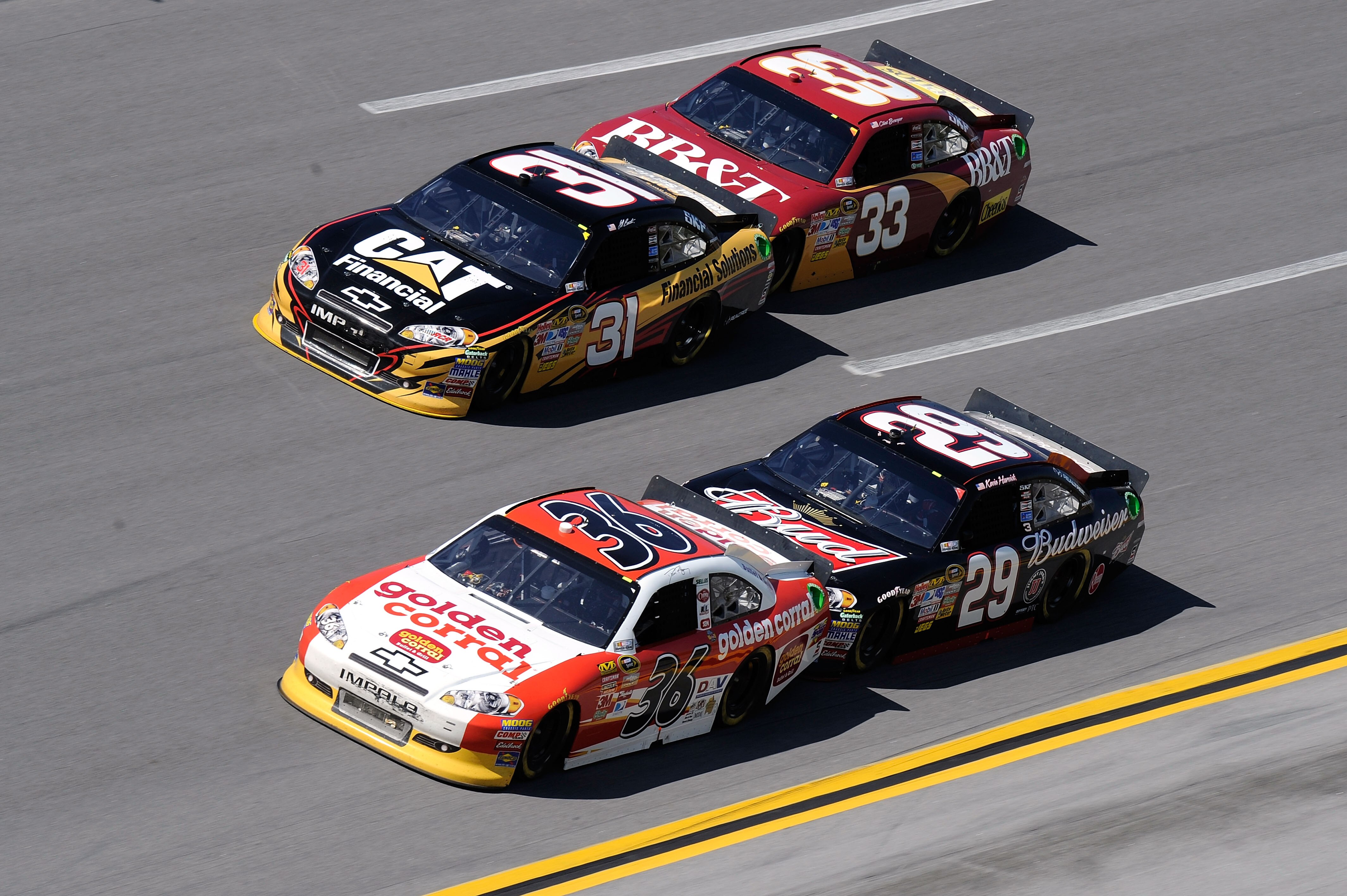 TALLADEGA, AL - APRIL 17:  Dave Blaney, driver of the #36 Golden Corral Chevrolet, and Jeff Burton, driver of the #31 Cat Financial Chevrolet, lead Kevin Harvick, driver of the #29 Budweiser Chevrolet, and Clint Bowyer, driver of the #33 BB&T Chevrolet, d