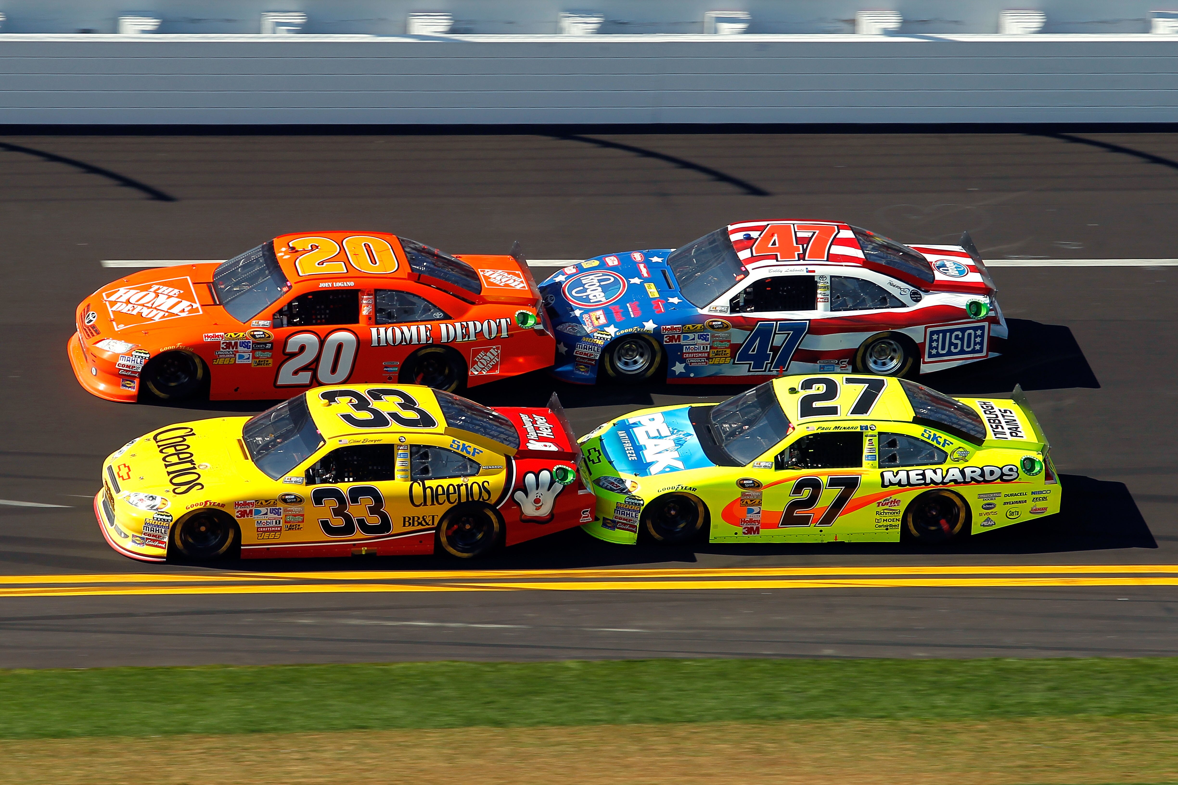 DAYTONA BEACH, FL - FEBRUARY 20:  Joey Logano, driver of the #20 Home Depot Toyota, Bobby Labonte, driver of the #47 Kroger/USO Toyota, Clint Bowyer, driver of the #33 Cheerios Chevrolet, and Paul Menard, driver of the #27 Menards Chevrolet, race during t