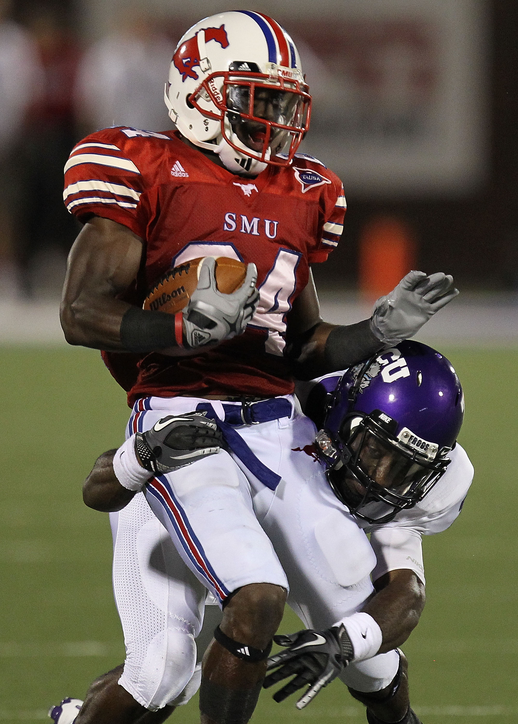 DALLAS - SEPTEMBER 24:   Wide receiver Aldrick Robinson #24 of the SMU Mustangs is tackled by Greg McCoy #7 of the TCU Horned Frogs at Gerald J. Ford Stadium on September 24, 2010 in Dallas, Texas.  (Photo by Ronald Martinez/Getty Images)
