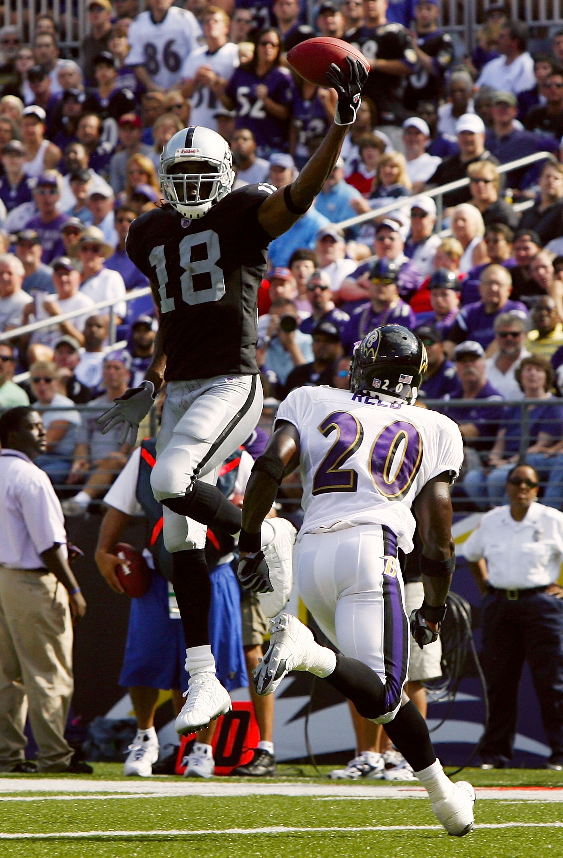 BALTIMORE - SEPTEMBER 17:  Randy Moss #18 of the Oakland Raiders leaps for a pass over Baltimore Ravens safety Ed Reed #20 in fourth quarter action on September 17, 2006 at M&T Bank Stadium in Baltimore, Maryland. The Ravens defeated the Raiders 28-6.  (P