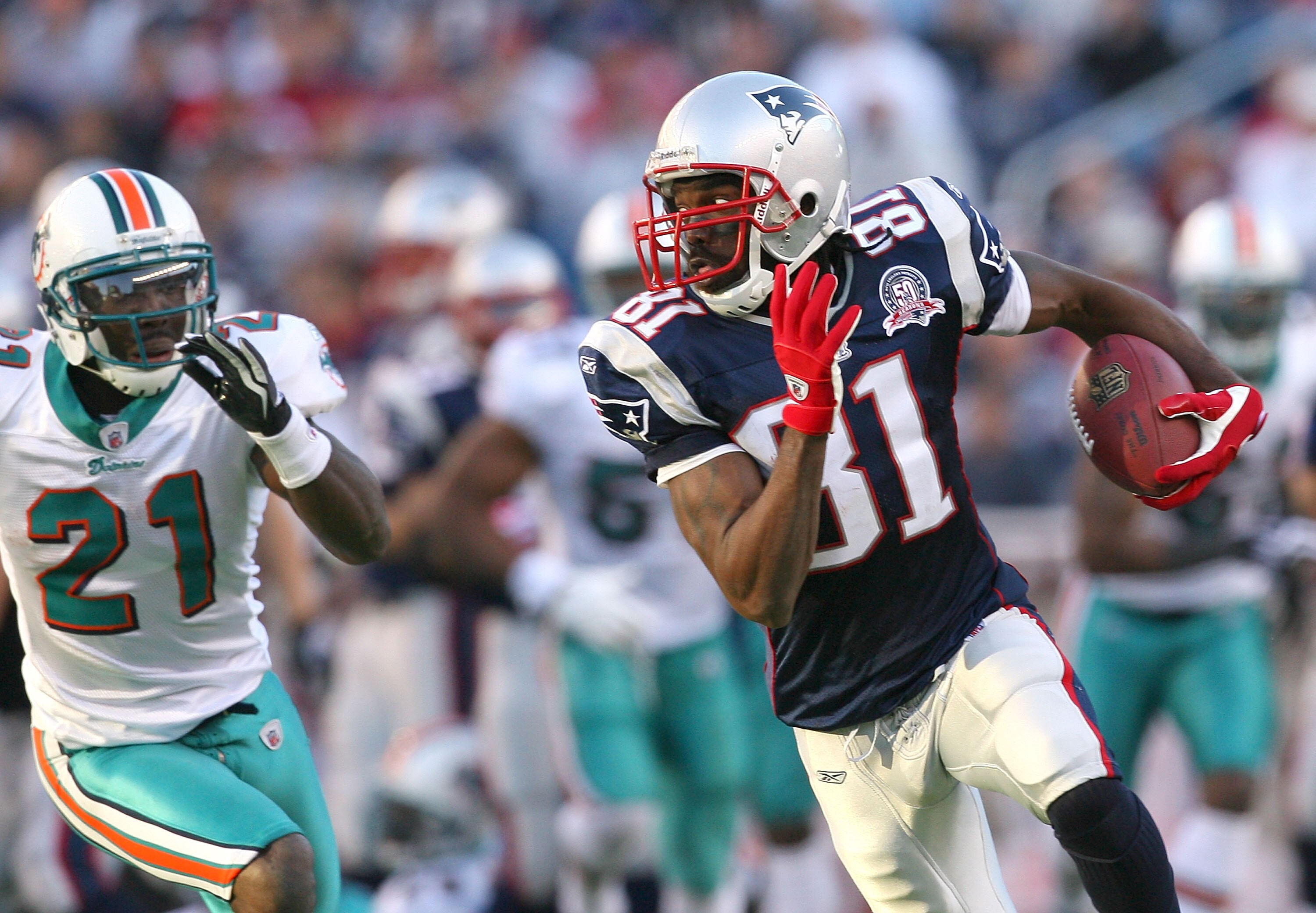 FOXBORO, MA - NOVEMBER 8:  Randy Moss #81 of the New England Patriots gains yards against the defense of Vontae Davis of the Miami Dolphins gives chase at Gillette Stadium on November 8, 2009 in Foxboro, Massachusetts. The Patriots won 27-17. (Photo by Ji