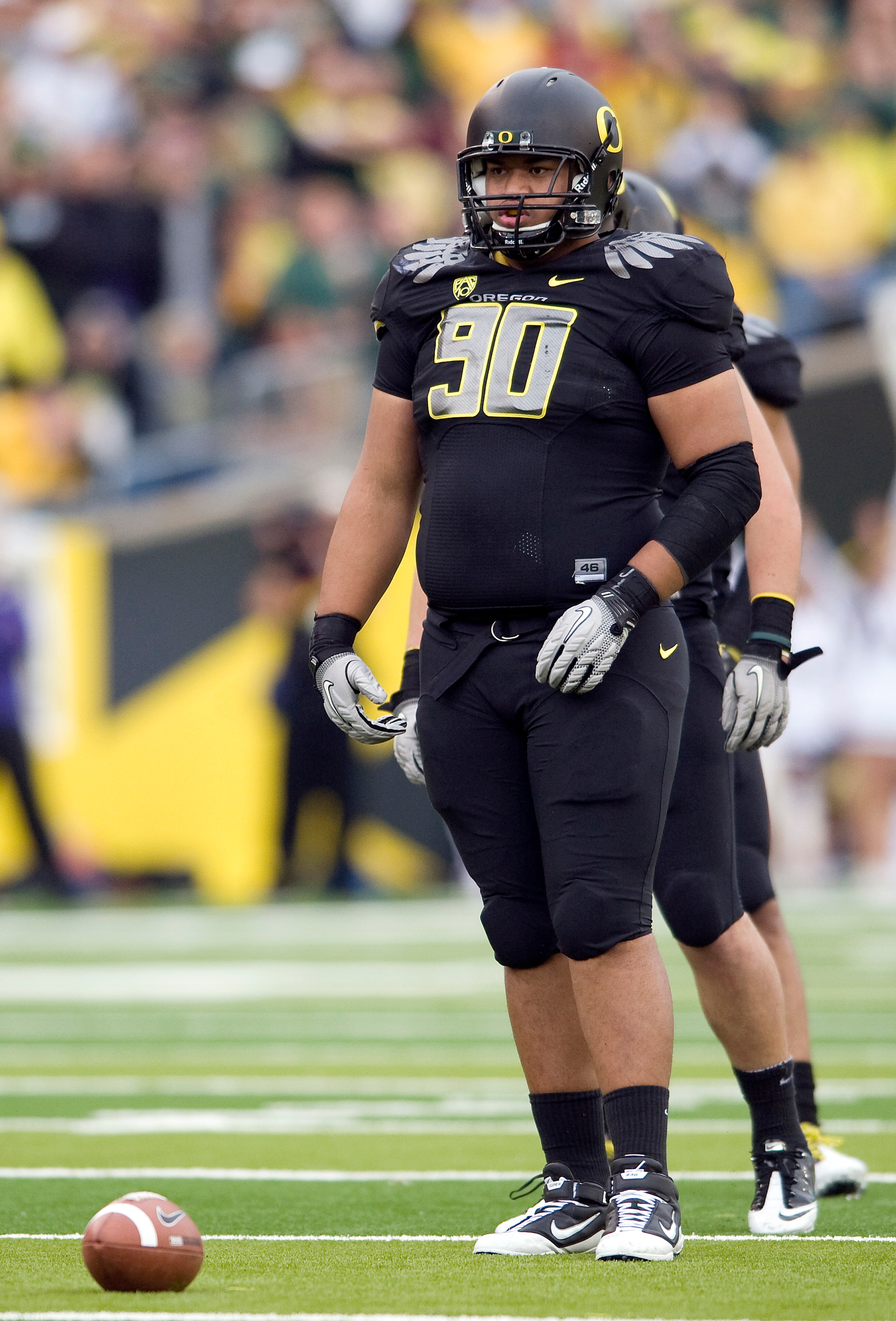 EUGENE, OR - NOVEMBER 06: Defensive tackle Ricky Heimuli #90 of the Oregon Ducks stands at the line of scrimmage in the first quarter of the game against the Washington Huskies at Autzen Stadium on November 6, 2010 in Eugene, Oregon. The Ducks won the gam