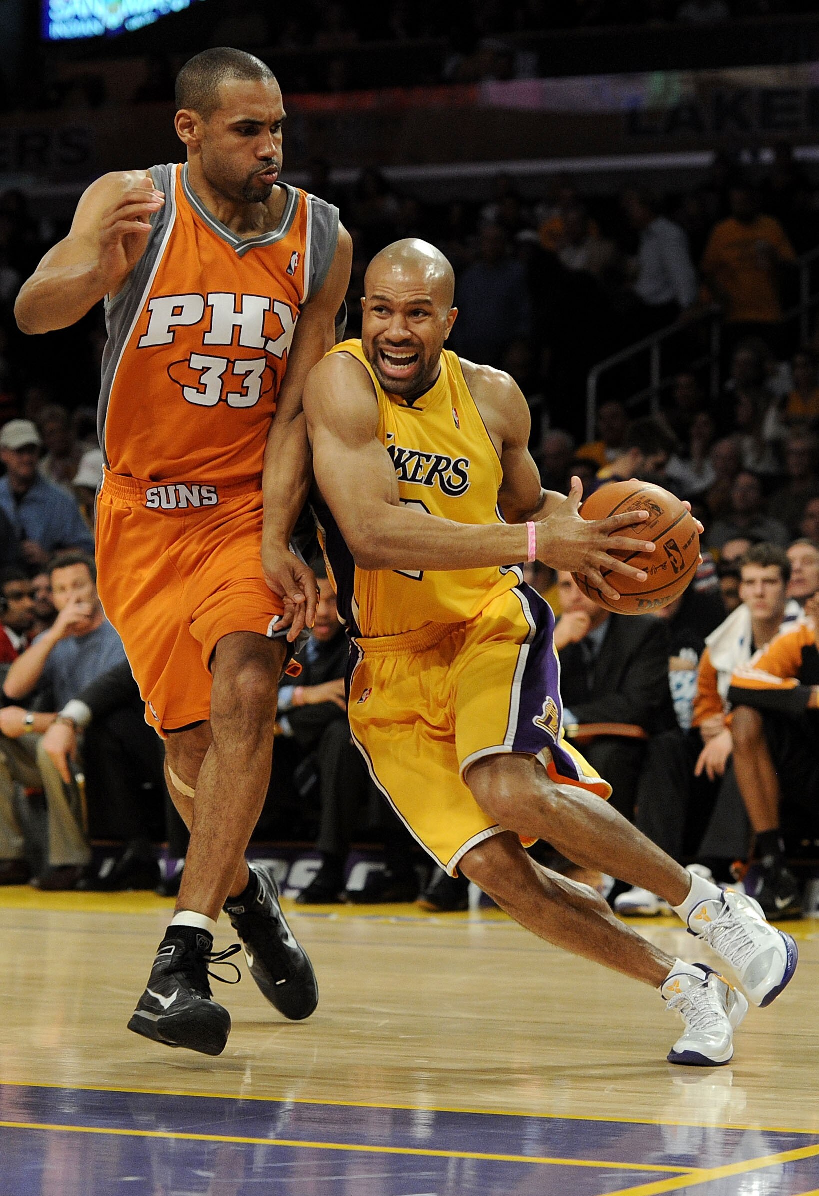 LOS ANGELES, CA - MAY 19:  Derek Fisher #2 of the Los Angeles Lakers drives with the ball as Grant Hill #33 of the Phoenix Suns defends in the third quarter of Game Two of the Western Conference Finals during the 2010 NBA Playoffs at Staples Center on May