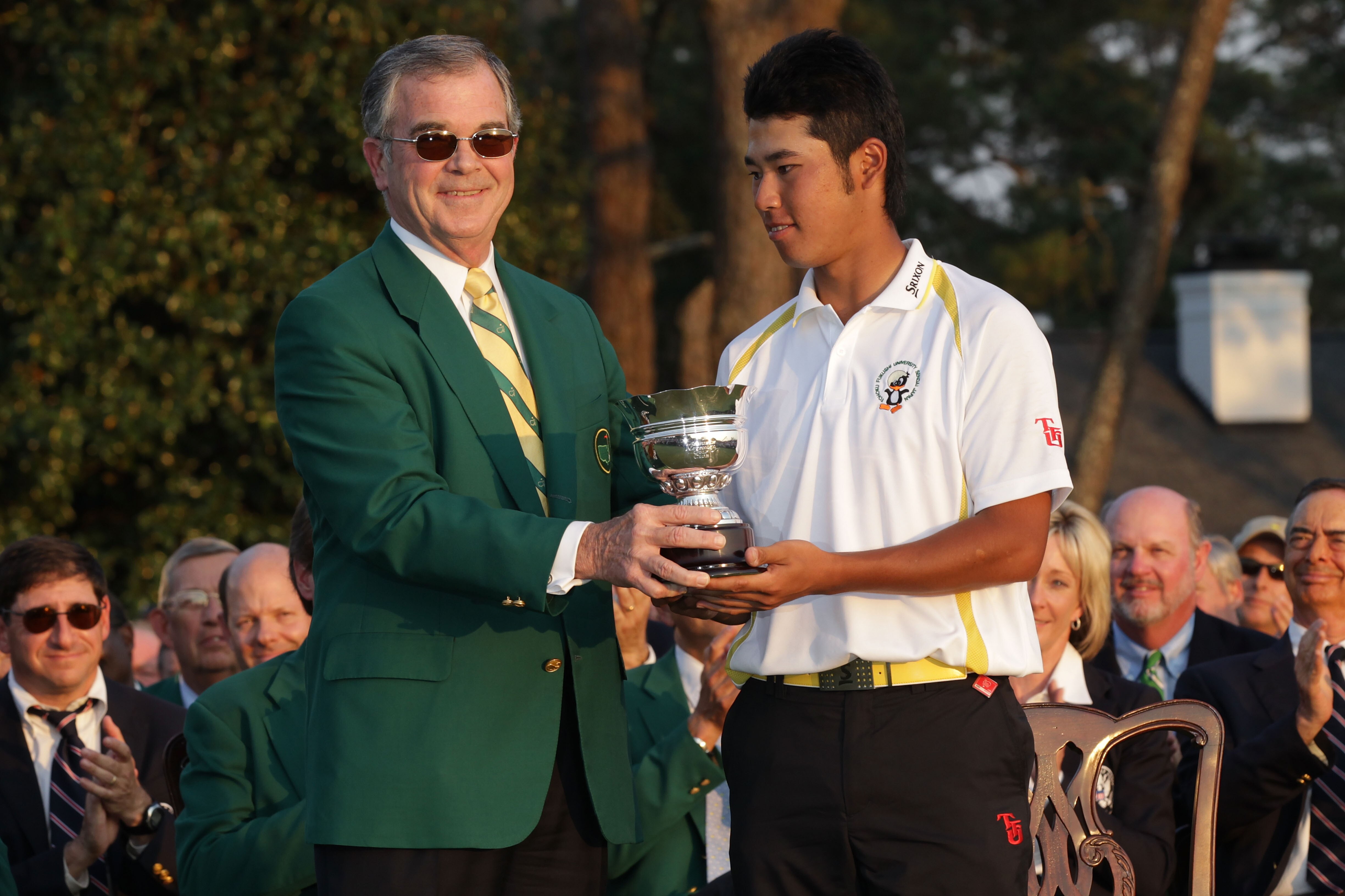 AUGUSTA, GA - APRIL 10:  William Porter Payne (L) presents a trophy to the leading amateur Hideki Matsuyama of Japan during the final round of the 2011 Masters Tournament on April 10, 2011 in Augusta, Georgia.  (Photo by David Cannon/Getty Images)