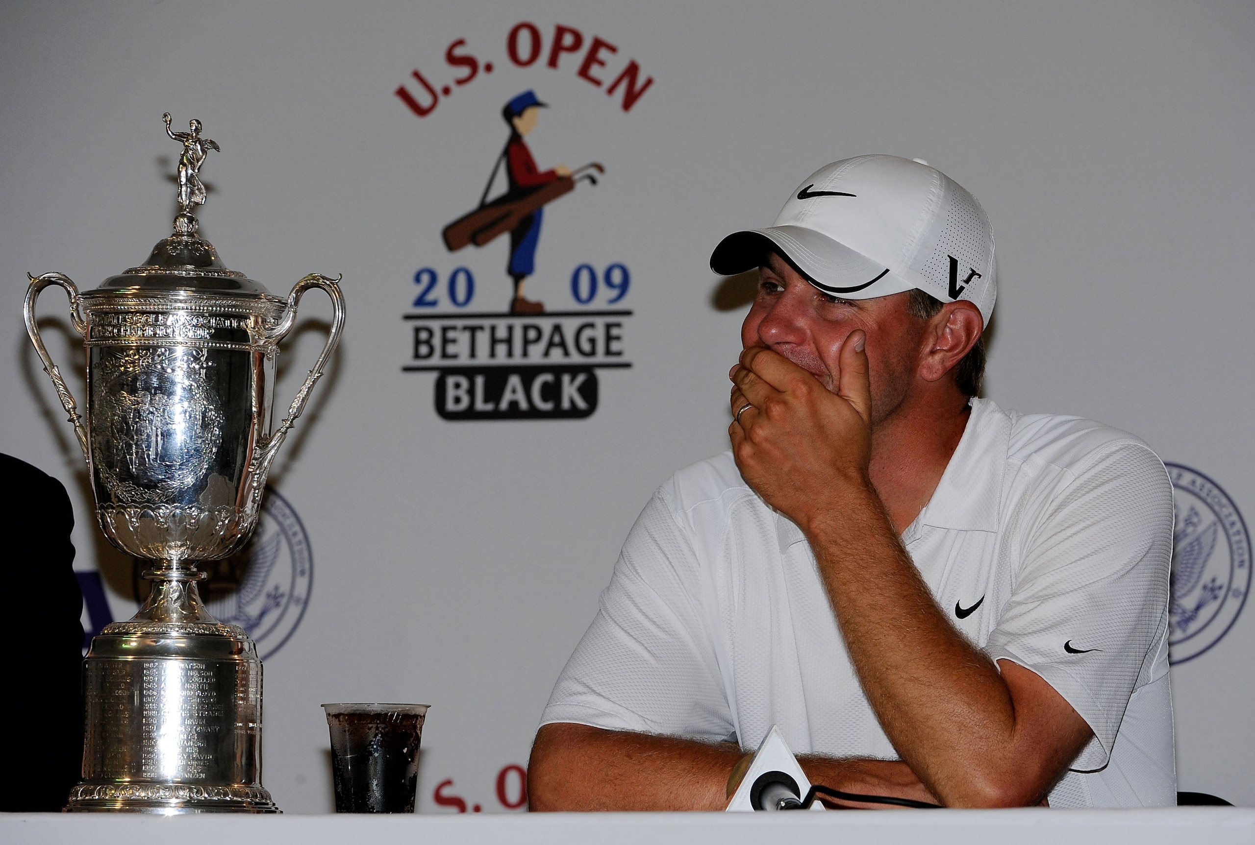FARMINGDALE, NY - JUNE 22: Lucas Glover speaks with the media after alongside the winner's trophy after his two-stroke victory at the 109th U.S. Open on the Black Course at Bethpage State Park on June 22, 2009 in Farmingdale, New York. (Photo by Sam Gre FARMINGDALE, NY - JUNE 22: Lucas Glover speaks with the media after alongside the winner's trophy after his two-stroke victory at the 109th U.S. Open on the Black Course at Bethpage State Park on June 22, 2009 in Farmingdale, New York. (Photo by Sam Gre