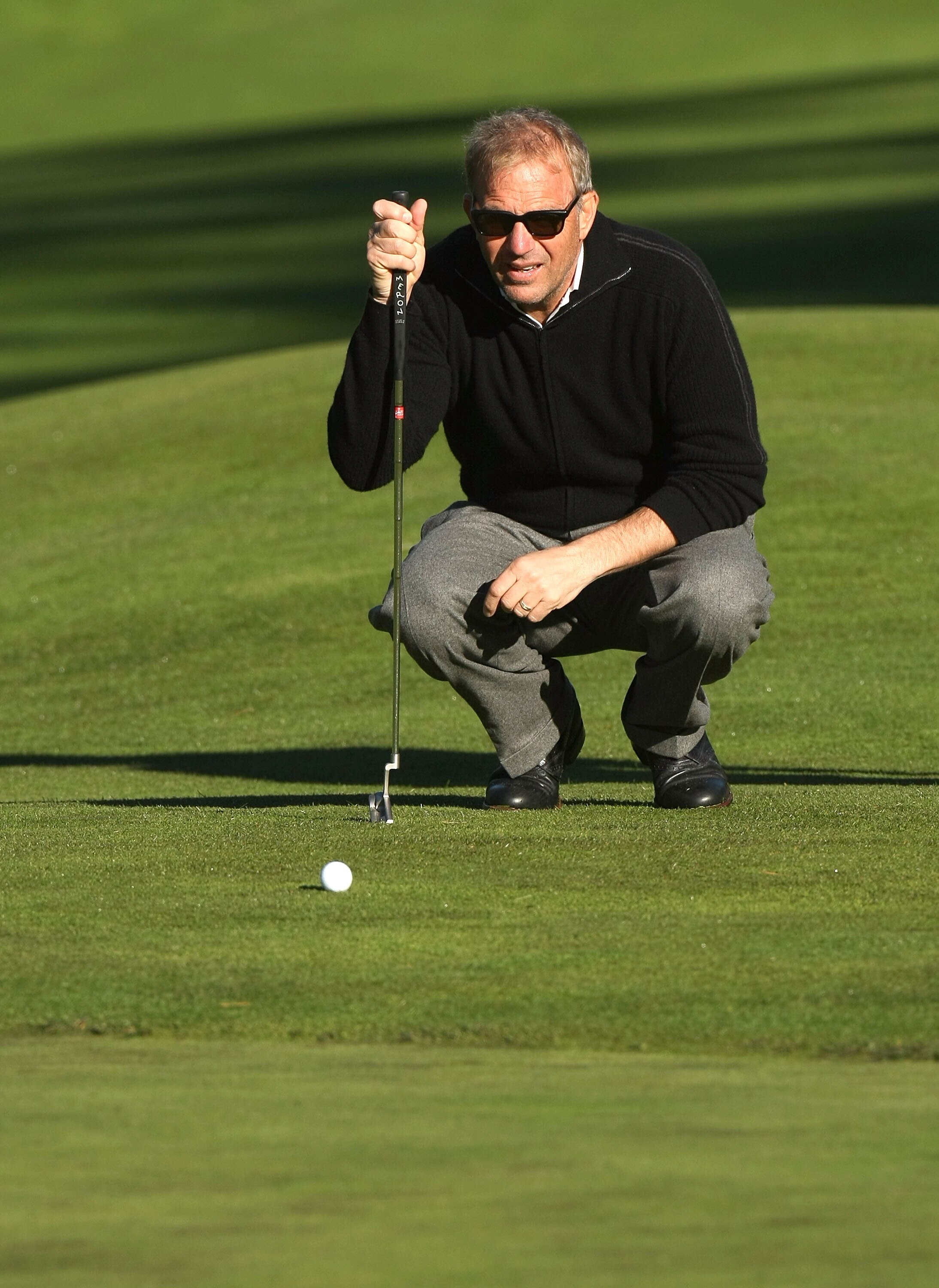 PEBBLE BEACH, CA - FEBRUARY 07:  Actor Kevin Costner lines up his putt on the third hole during the first round of the AT&T Pebble Beach National Pro-Am at Poppy Hills Golf Course February 7, 2008  in Pebble Beach, California.  (Photo by Stephen Dunn/Gett