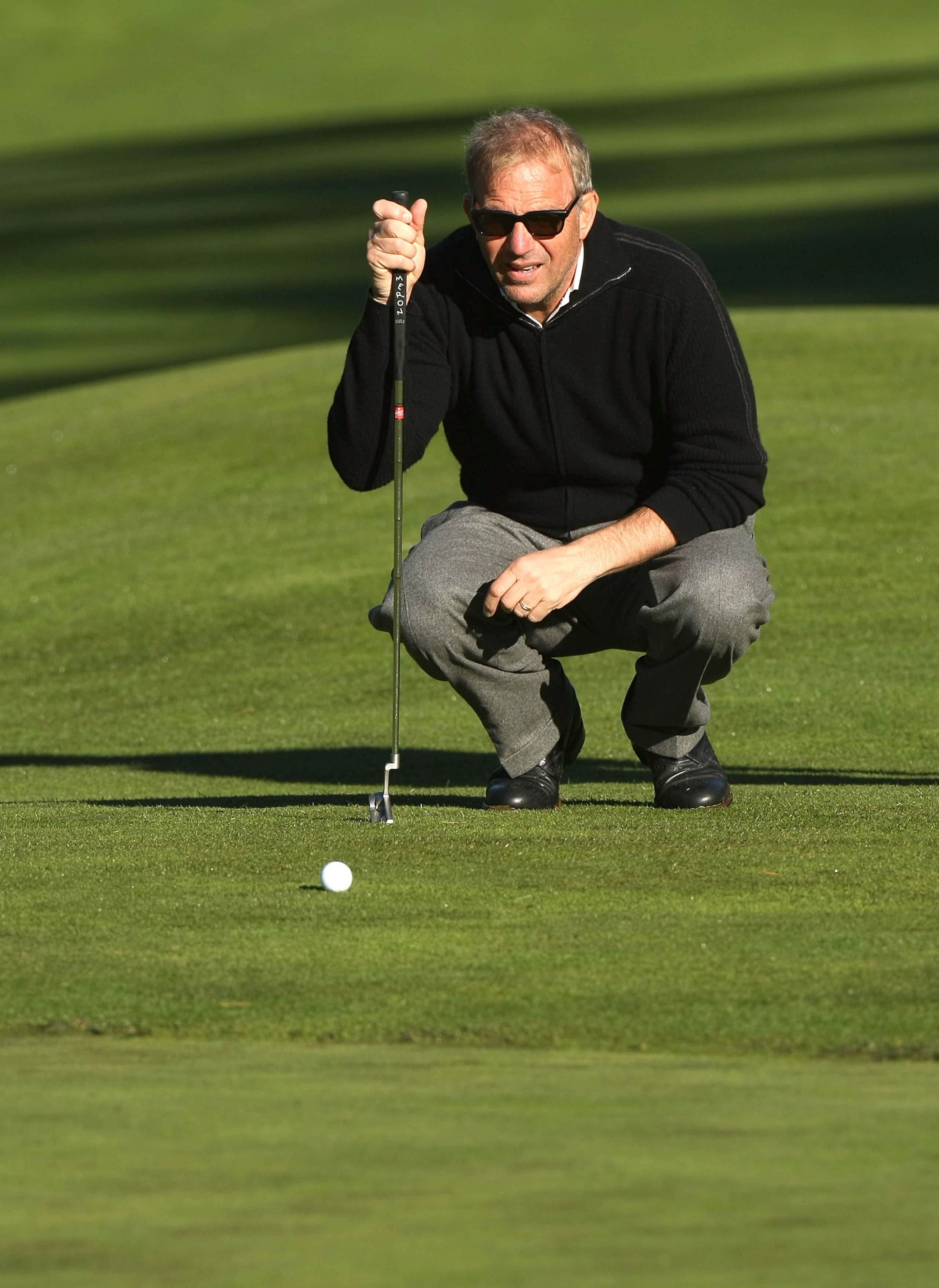 PEBBLE BEACH, CA - FEBRUARY 07: Actor Kevin Costner lines up his putt on the third hole during the first round of the AT&T Pebble Beach National Pro-Am at Poppy Hills Golf Course February 7, 2008 in Pebble Beach, California. (Photo by Stephen Dunn/Gett PEBBLE BEACH, CA - FEBRUARY 07: Actor Kevin Costner lines up his putt on the third hole during the first round of the AT&T Pebble Beach National Pro-Am at Poppy Hills Golf Course February 7, 2008 in Pebble Beach, California. (Photo by Stephen Dunn/Gett