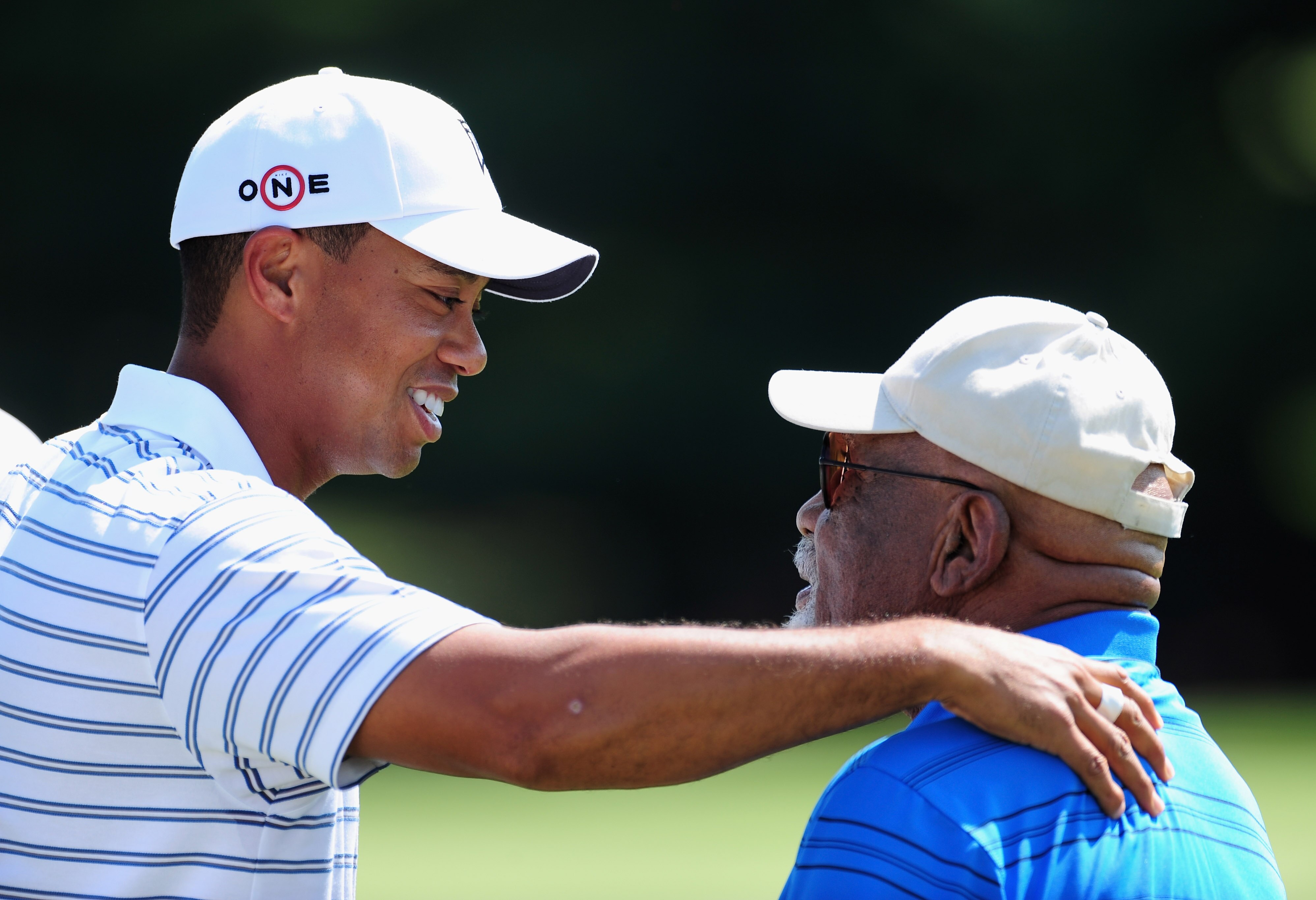 AKRON, OH - AUGUST 05:  Tiger Woods of USA speaks with Charlie Sifford the first African American inducted into the World Golf Hall of Fame during a practice round of the World Golf Championship Bridgestone Invitational on August 5, 2009 at Firestone Coun