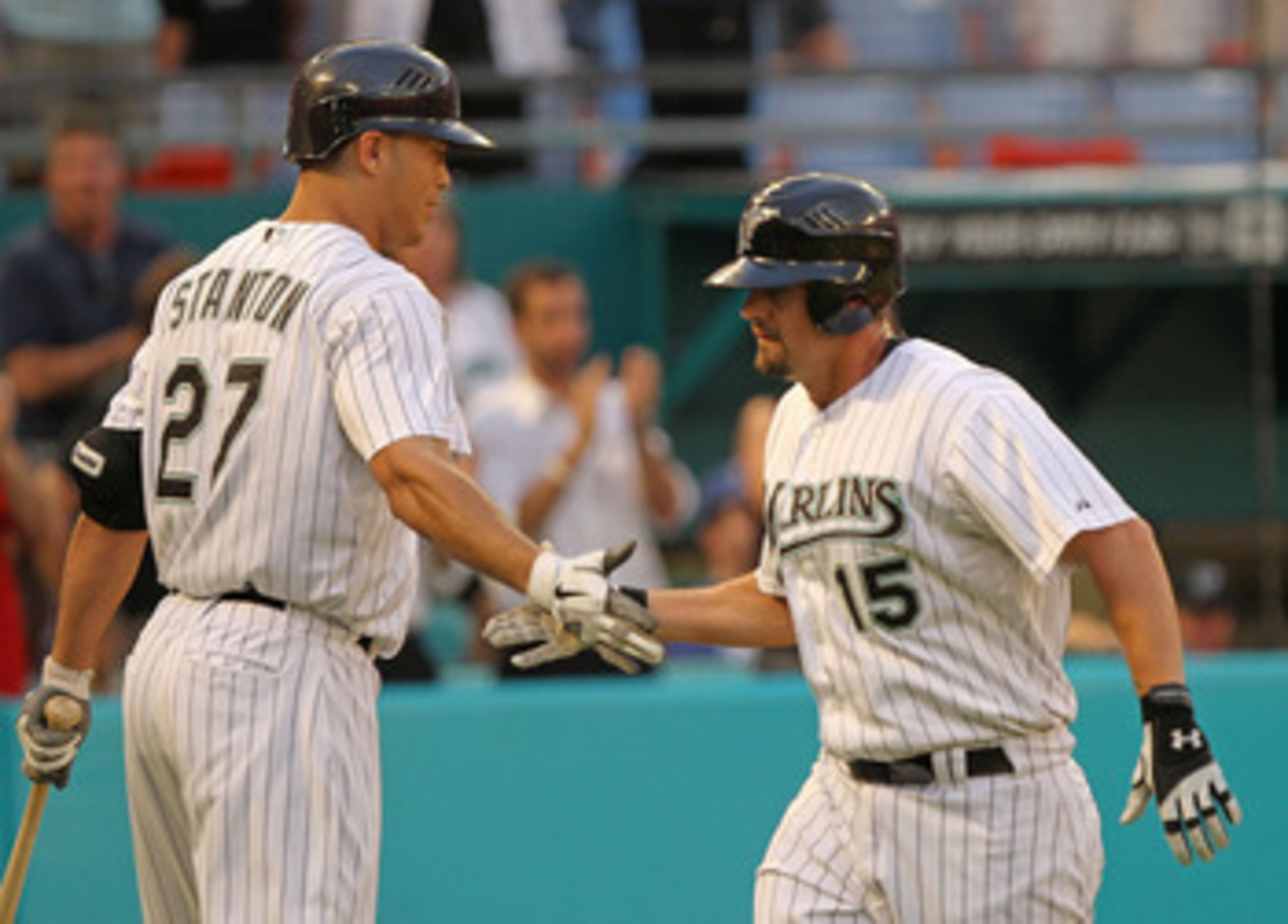 MIAMI GARDENS, FL - APRIL 26:  Gaby Sanchez #15 of the Florida Marlins is congratulated by Mike Stanton #27 after hitting a HR during a game against the Los Angeles Dodgers at Sun Life Stadium on April 26, 2011 in Miami Gardens, Florida.  (Photo by Mike E