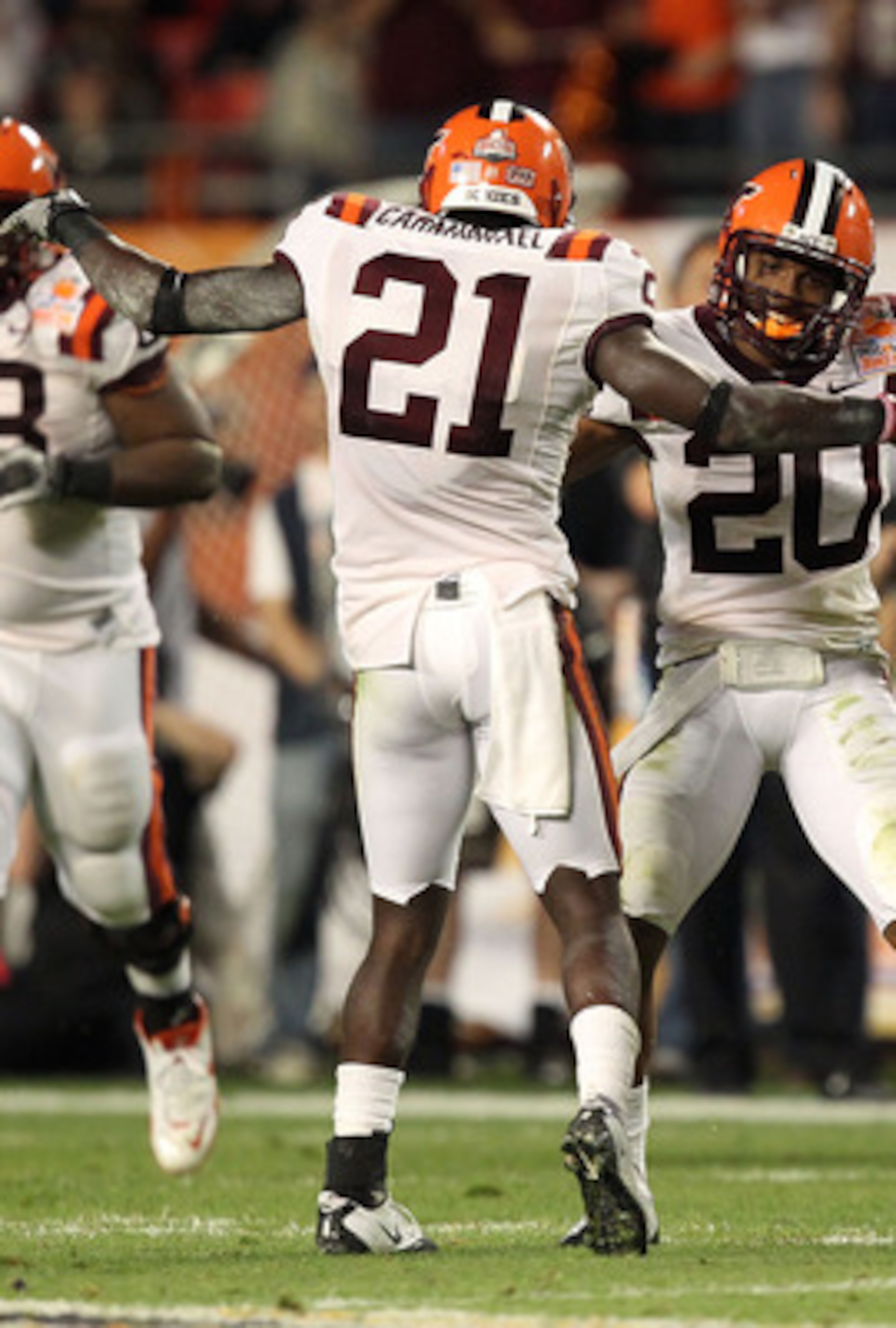 MIAMI, FL - JANUARY 03:  Rashad Carmichael #21 and Jayron Hosley #20 of the Virginai Tech Hokies celebrate after Hosley intercepted a pass in the second quarter against the Stanford Cardinal during the 2011 Discover Orange Bowl at Sun Life Stadium on Janu
