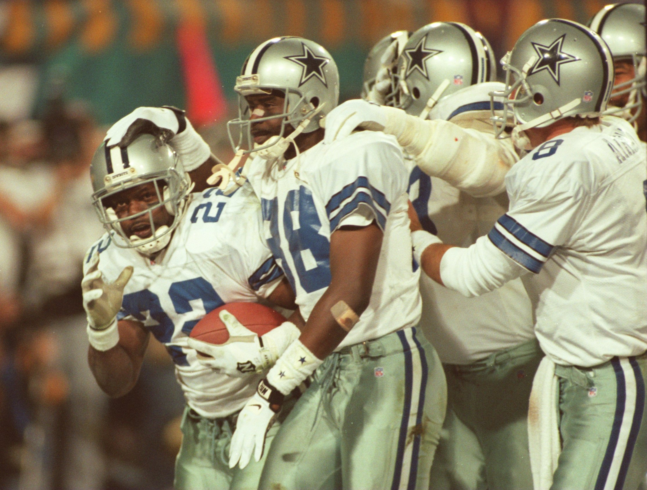 28 Jan 1996:  Running back Emmitt Smith #22 of the Dallas Cowboys is congratulated by teammates, including wide receiver Michael Irvin #88 and quarterback Troy Aikman #8, after scoring his second touchdown of the game in the fourth quarter of Super Bowl X