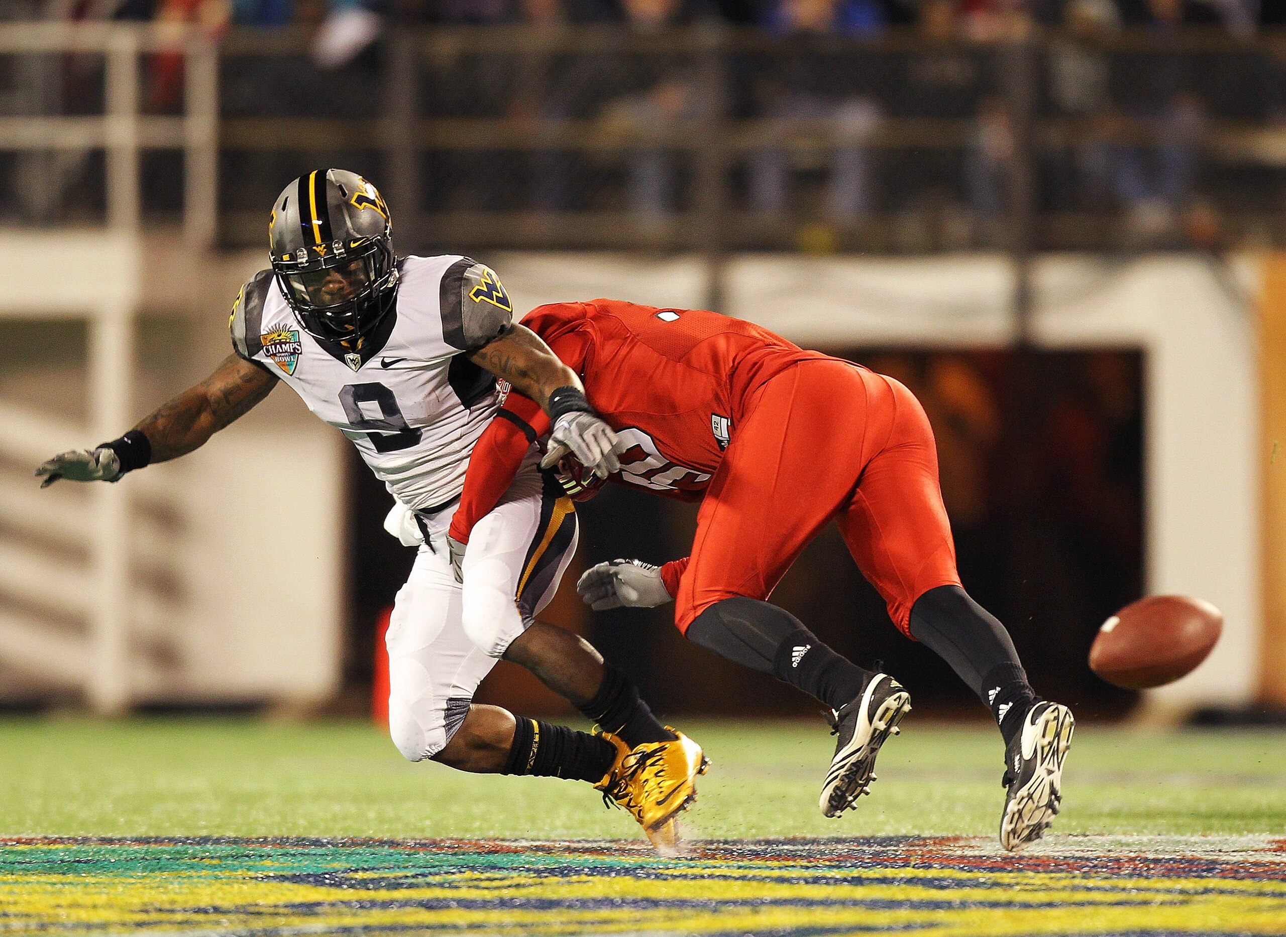 ORLANDO, FL - DECEMBER 28: Jock Sanders #9 of the West Virginia Mountineers misses a catch defended by Nate Irving #56 of the North Carolina State Wolfpack during the Champs Sports Bowl at Florida Citrus Bowl Stadium on December 28, 2010 in Orlando, Flor ORLANDO, FL - DECEMBER 28: Jock Sanders #9 of the West Virginia Mountineers misses a catch defended by Nate Irving #56 of the North Carolina State Wolfpack during the Champs Sports Bowl at Florida Citrus Bowl Stadium on December 28, 2010 in Orlando, Flor