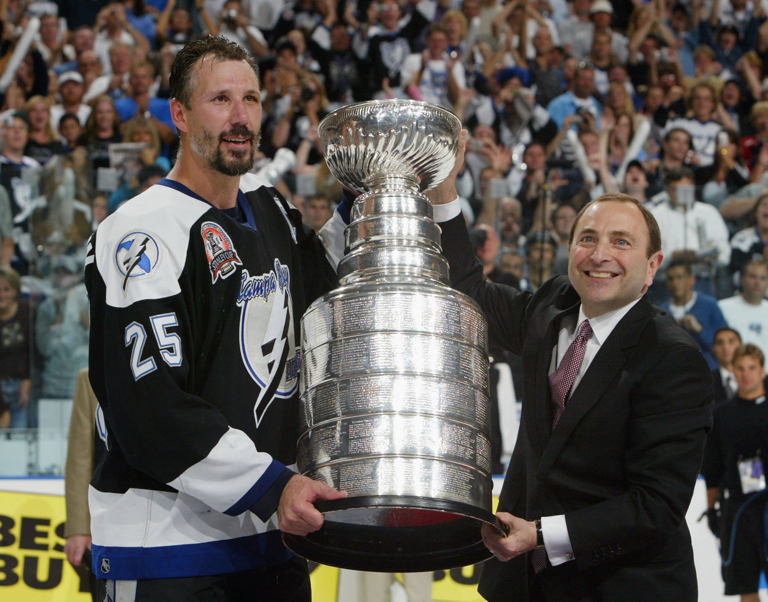 TAMPA, FL - JUNE 7: Dave Andreychuk #25 of the Tampa Bay Lightning receives the Stanley Cup from NHL commissioner Gary Bettman after defeating the Calgary Flames 2-1 in game seven of the NHL Stanley Cup Finals on June 7, 2004 at the St. Pete Times Forum TAMPA, FL - JUNE 7: Dave Andreychuk #25 of the Tampa Bay Lightning receives the Stanley Cup from NHL commissioner Gary Bettman after defeating the Calgary Flames 2-1 in game seven of the NHL Stanley Cup Finals on June 7, 2004 at the St. Pete Times Forum