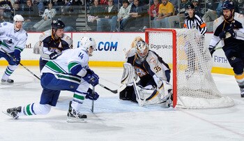 NASHVILLE, TN - MARCH 29:  Alexandre Burrows #14 of the Vancouver Canucks scores a goal on Pekka Rinne #35 of the Nashville Predators on March 29, 2011 at the Bridgestone Arena in Nashville, Tennessee.  (Photo by Frederick Breedon/Getty Images)