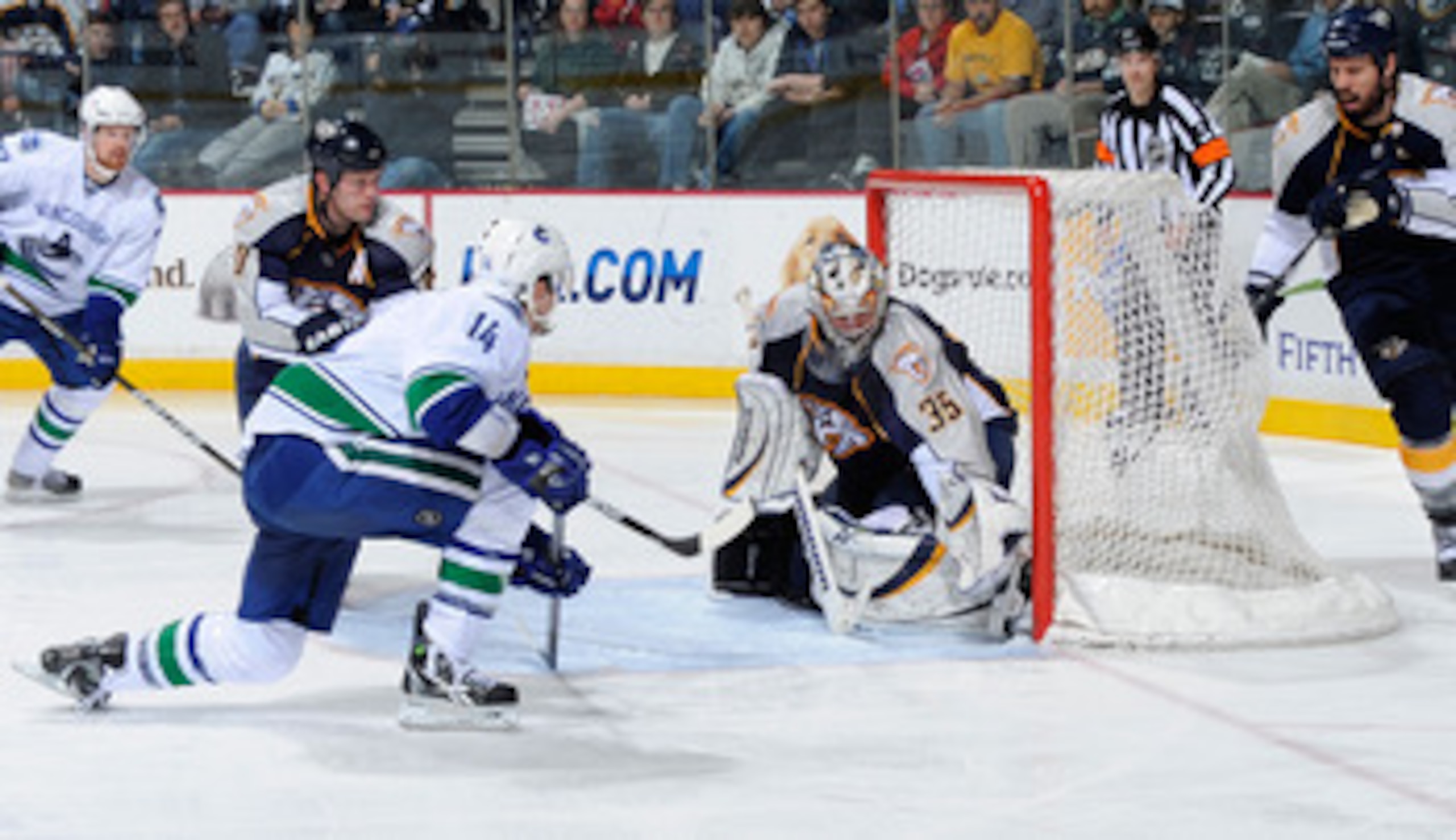 NASHVILLE, TN - MARCH 29:  Alexandre Burrows #14 of the Vancouver Canucks scores a goal on Pekka Rinne #35 of the Nashville Predators on March 29, 2011 at the Bridgestone Arena in Nashville, Tennessee.  (Photo by Frederick Breedon/Getty Images)