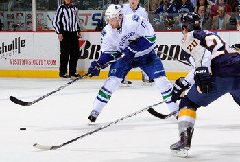 NASHVILLE, TN - MARCH 29:  Ryan Kesler #17 of the Vancouver Canucks carries the puck toward Ryan Suter #20 of the Nashville Predators on March 29, 2011 at the Bridgestone Arena in Nashville, Tennessee.  (Photo by Frederick Breedon/Getty Images)