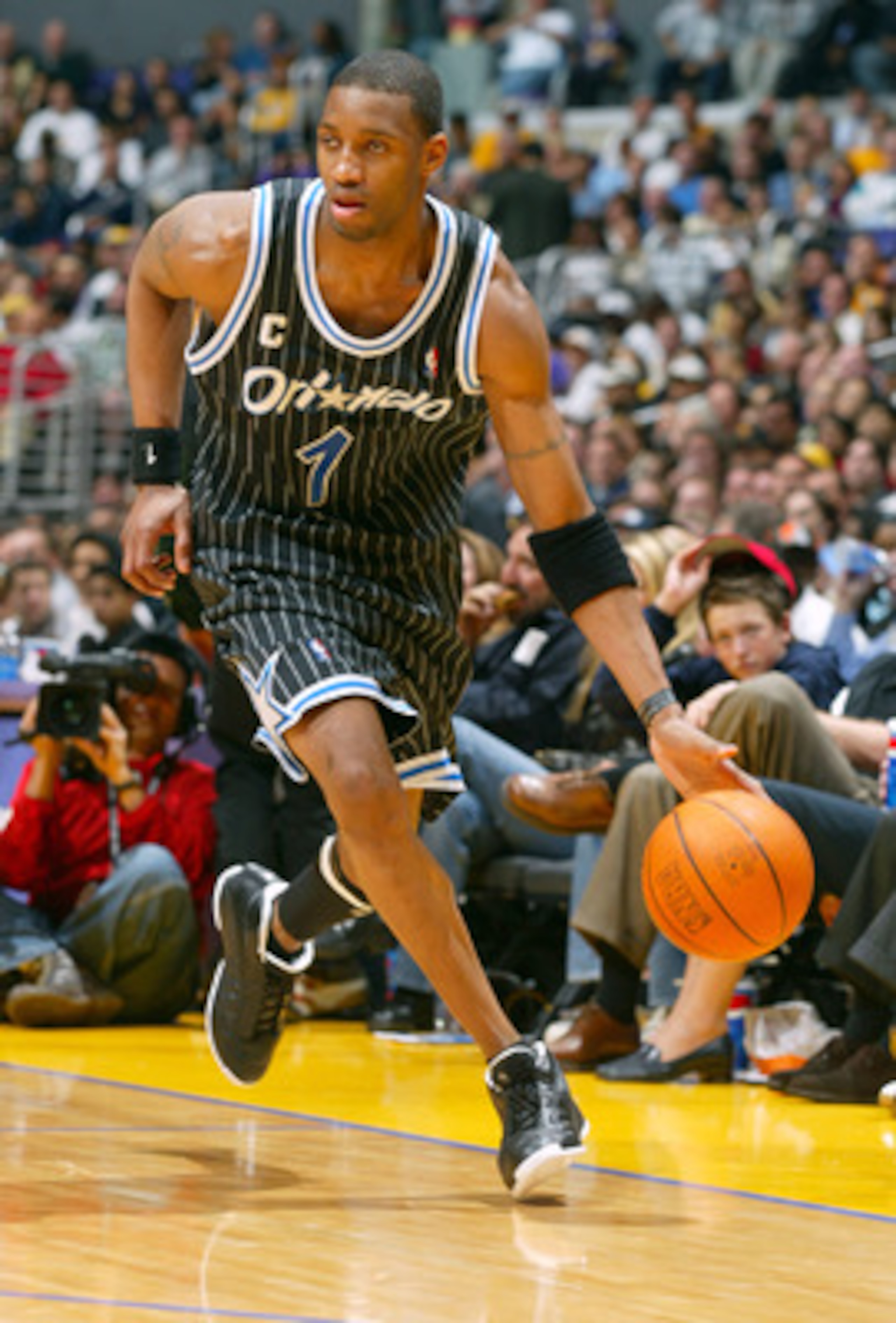 LOS ANGELES - MARCH 15:  Tracy McGrady #1 of the Orlando Magic drives upcourt during the game against the Los Angeles Lakers at Staples Center on March 15, 2004 in Los Angeles, California.  The Lakers won 113-110.   NOTE TO USER: User expressly acknowledg