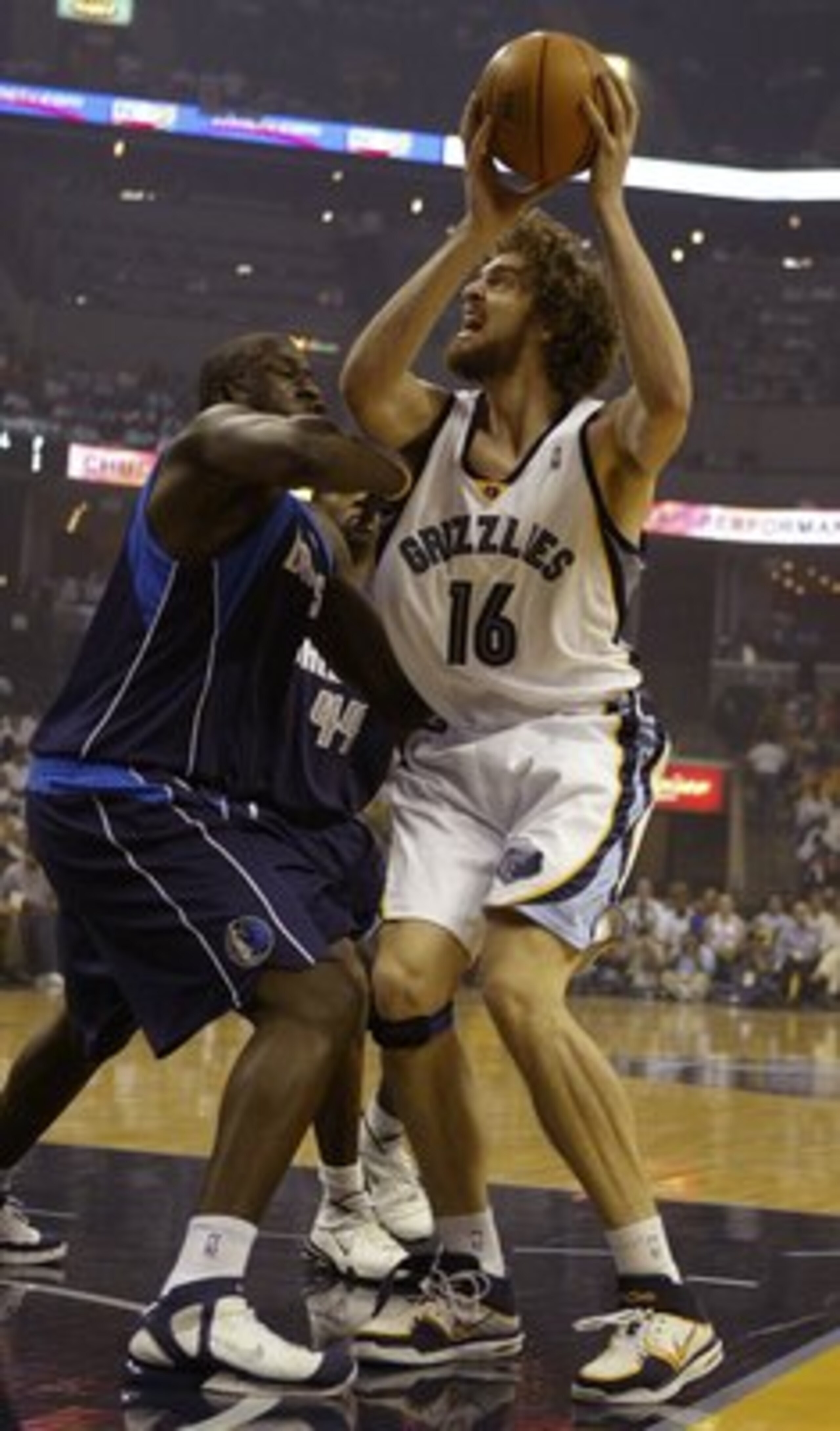 MEMPHIS - MAY 1:  Pau Gasol #16 of the Memphis Grizzlies takes a shot as DeSagana Diop #7 of the Dallas Mavericks defends in game four of the Western Conference Quarterfinals during the 2006 NBA Playoffs at FedExForum on May 1, 2006 in Memphis, Tennessee.