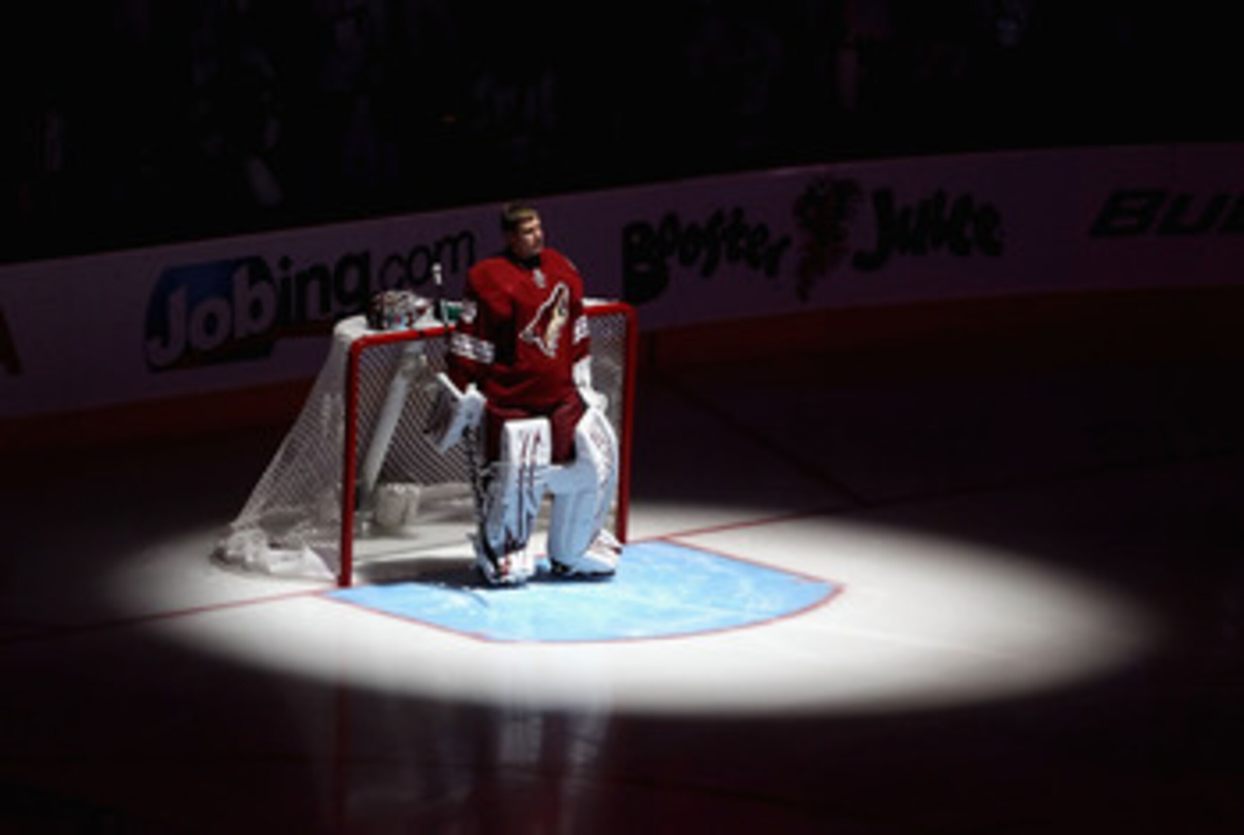 GLENDALE, AZ - APRIL 20:  Goaltender Ilya Bryzgalov #30 of the Phoenix Coyotes stands attended for the National Anthem before Game Four of the Western Conference Quarterfinals against the Detroit Red Wings during the 2011 NHL Stanley Cup Playoffs at Jobin