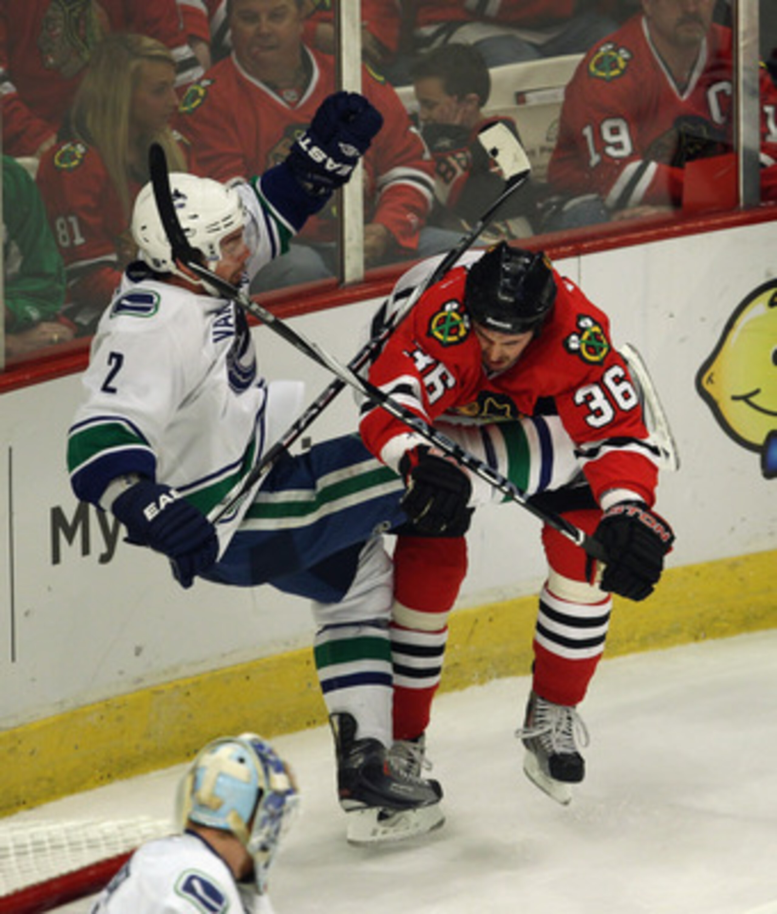 CHICAGO, IL - APRIL 24: Dave Bolland #36 of the Chicago Blackhawks hits Dan Hamhuis #2 of the Vancouver Canucks in Game Six of the Western Conference Quarterfinals during the 2011 NHL Stanley Cup Playoffs at the United Center on April 24, 2011 in Chicago,