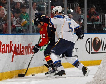 SUNRISE, FL - FEBRUARY 8: Barret Jackman #5 of the St. Louis Blues checks Marty Reasoner #19 of the Florida Panthers on February 8, 2011 at the BankAtlantic Center in Sunrise, Florida. The Blues defeated the Panthers 2-1. (Photo by Joel Auerbach/Getty Ima