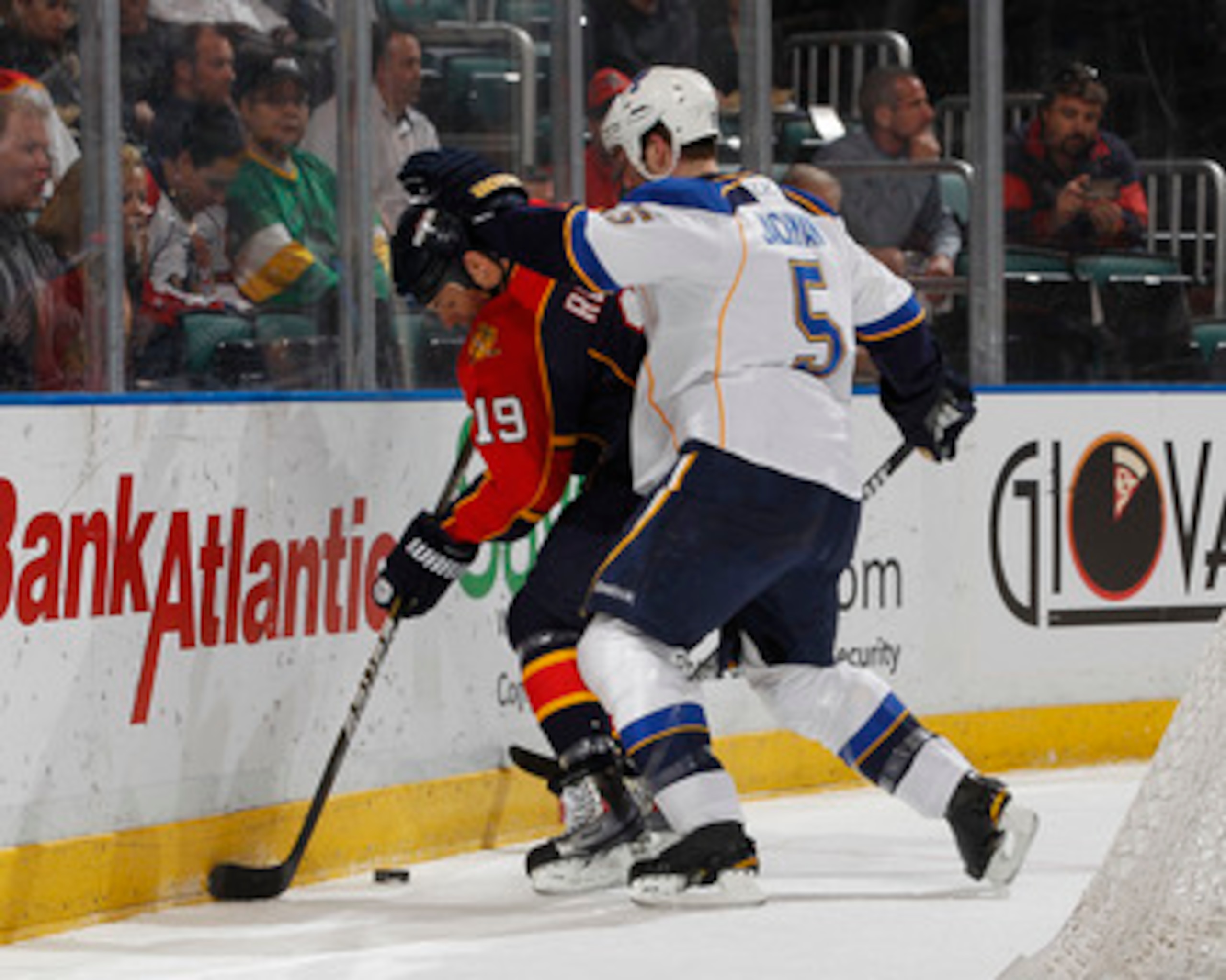 SUNRISE, FL - FEBRUARY 8: Barret Jackman #5 of the St. Louis Blues checks Marty Reasoner #19 of the Florida Panthers on February 8, 2011 at the BankAtlantic Center in Sunrise, Florida. The Blues defeated the Panthers 2-1. (Photo by Joel Auerbach/Getty Ima