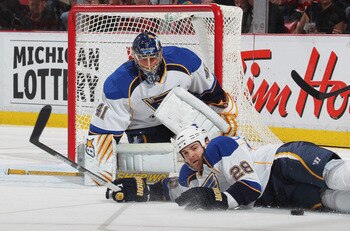 DETROIT, MI - NOVEMBER 17:  Carlo Colaiacovo #28 of the St. Louis Blues blocks a shot in front of teammate Jaroslav Halak #41 in a game against the Detroit Red Wings on November 17,2010 at the Joe Louis Arena in Detroit, Michigan. The Wings defeated the B