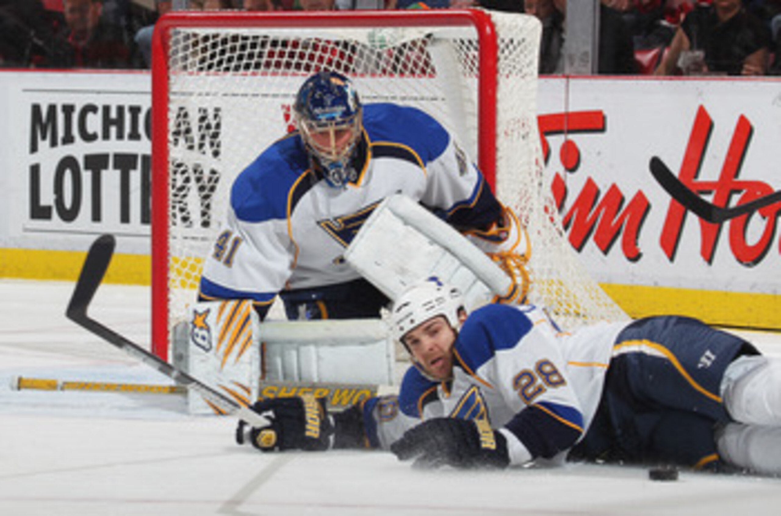 DETROIT, MI - NOVEMBER 17:  Carlo Colaiacovo #28 of the St. Louis Blues blocks a shot in front of teammate Jaroslav Halak #41 in a game against the Detroit Red Wings on November 17,2010 at the Joe Louis Arena in Detroit, Michigan. The Wings defeated the B