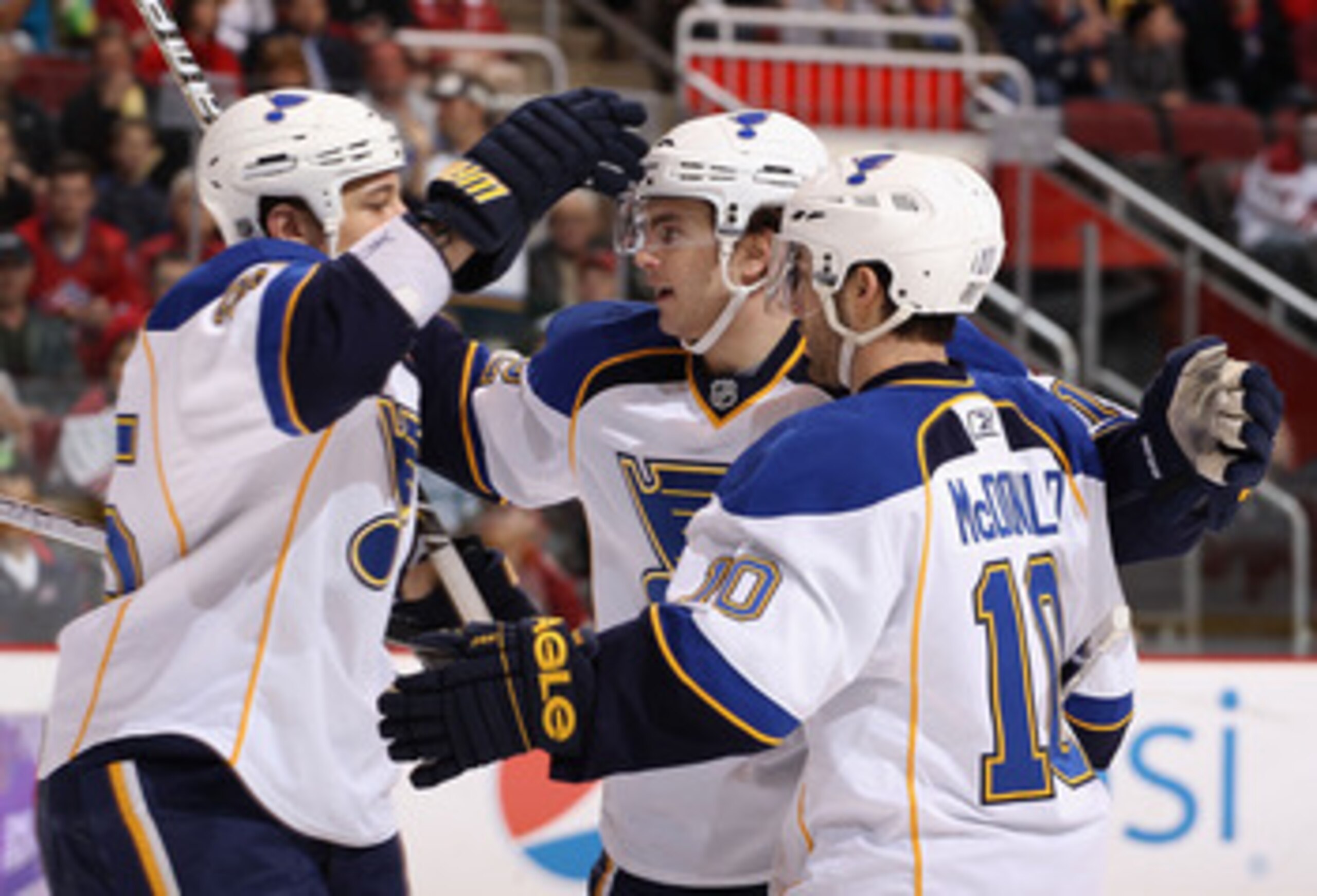 GLENDALE, AZ - MARCH 22:  Kevin Shattenkirk #12 (C) of the St. Louis Blues celebrates with teammates Chris Stewart #25 and Andy McDonald #10 after Shattenkirk scored a first period goal against the Phoenix Coyotes during the NHL game at Jobing.com Arena o
