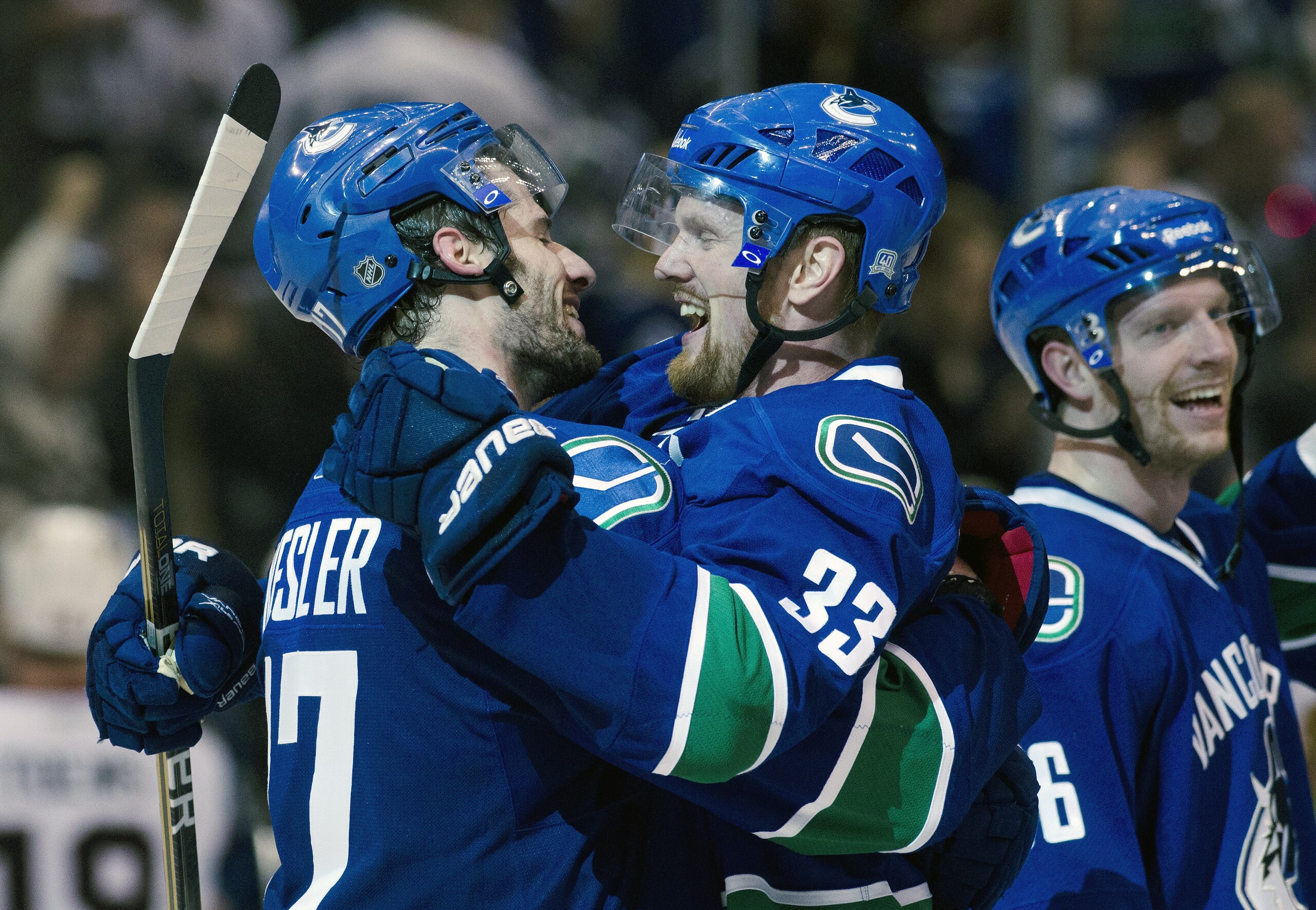 VANCOUVER, CANADA - APRIL 26: Henrik Sedin #33 (middle) and Ryan Kesler #17 of the Vancouver Canucks celebrates after defeating the Chicago Blackhawks 2-1in overtime of Game Seven of the Western Conference Quarterfinals during the 2011 NHL Stanley Cup Pla