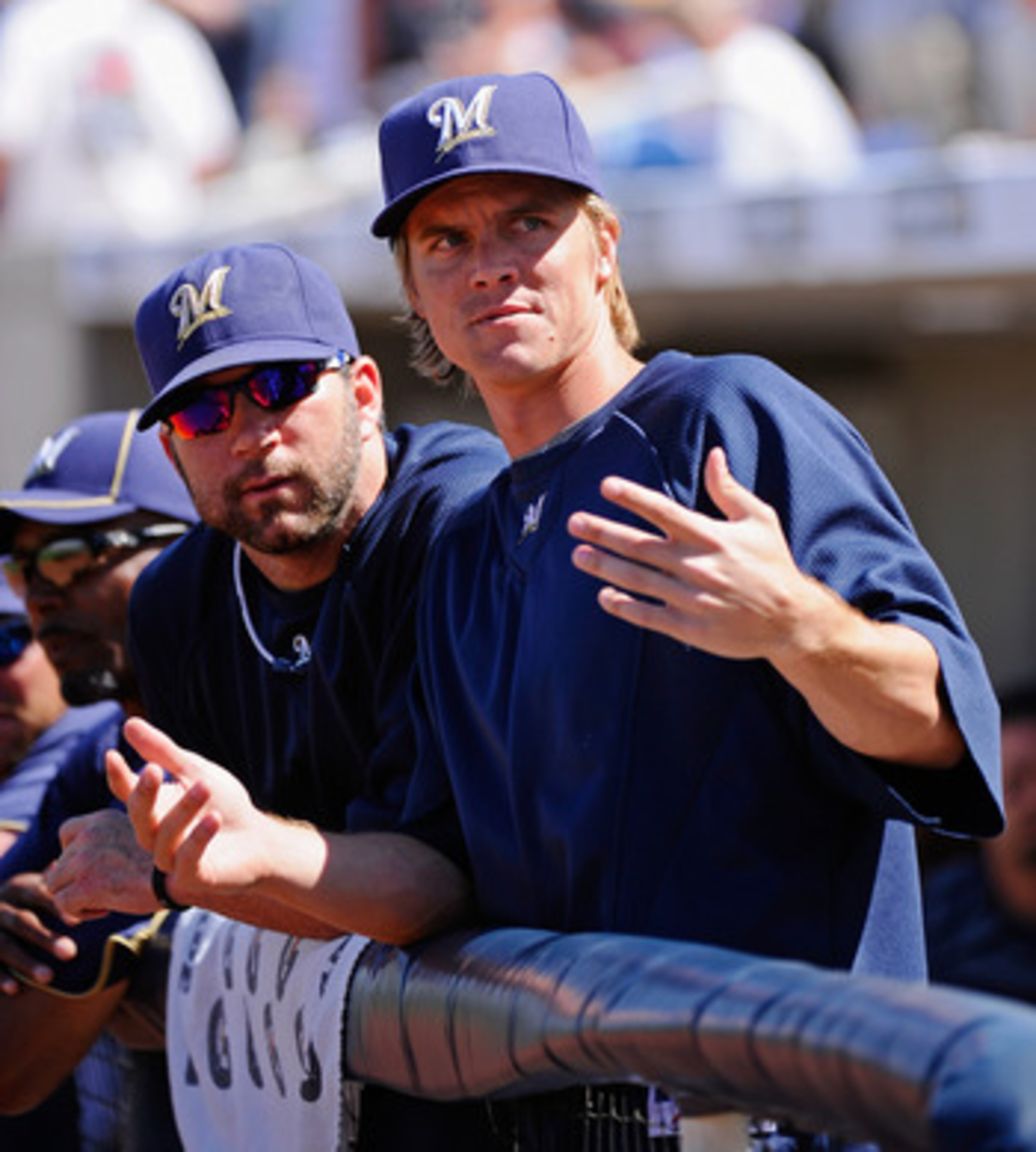 PHOENIX, AZ - MARCH 10:  Pitchers Zack Greinke #13 and Shaun Marcum #18  of the Milwaukee Brewers look at fans during the spring teaining baseball agme against Colorado Rockies at Maryvale Baseball Park on March 10, 2011 in Phoenix, Arizona.  (Photo by Ke