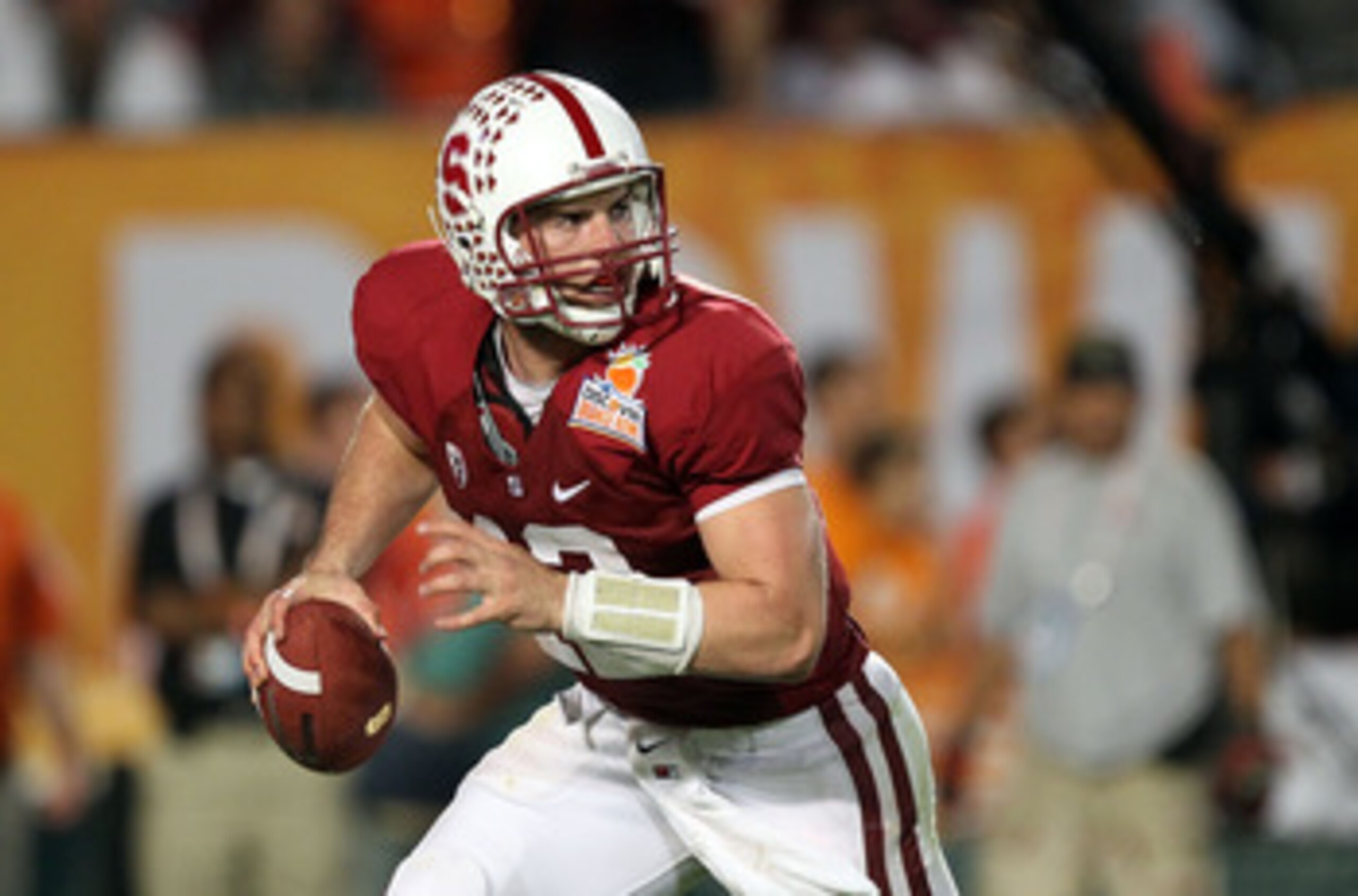 MIAMI, FL - JANUARY 03:  Quarterback Andrew Luck #12 of the Stanford Cardinal rolls out of the pocket against the Virginia Tech Hokies during the 2011 Discover Orange Bowl at Sun Life Stadium on January 3, 2011 in Miami, Florida. Stanford won 40-12. (Phot