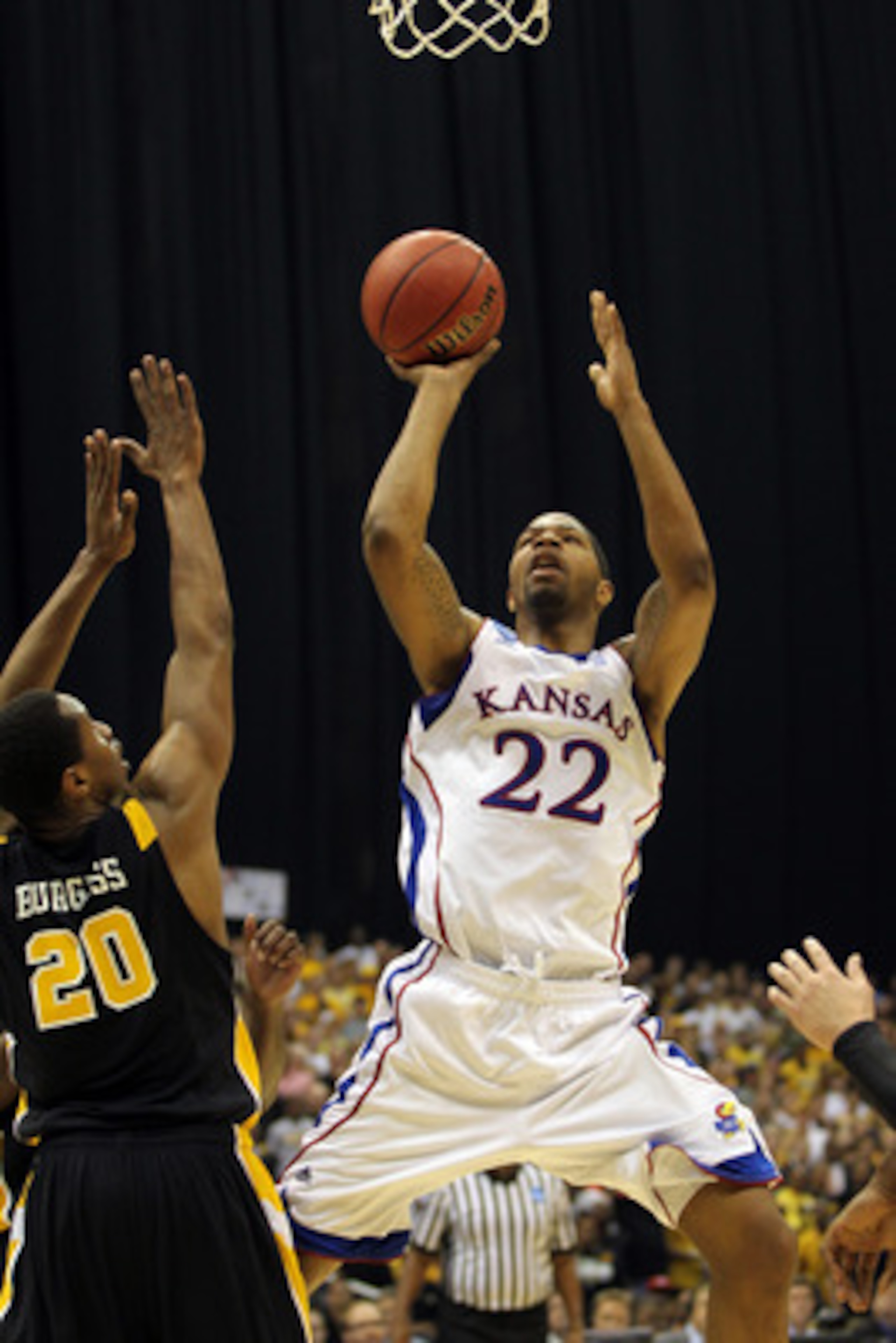 SAN ANTONIO, TX - MARCH 27:  Marcus Morris #22 of the Kansas Jayhawks puts up a shot against Bradford Burgess #20 of the Virginia Commonwealth Rams during the southwest regional final of the 2011 NCAA men's basketball tournament at the Alamodome on March