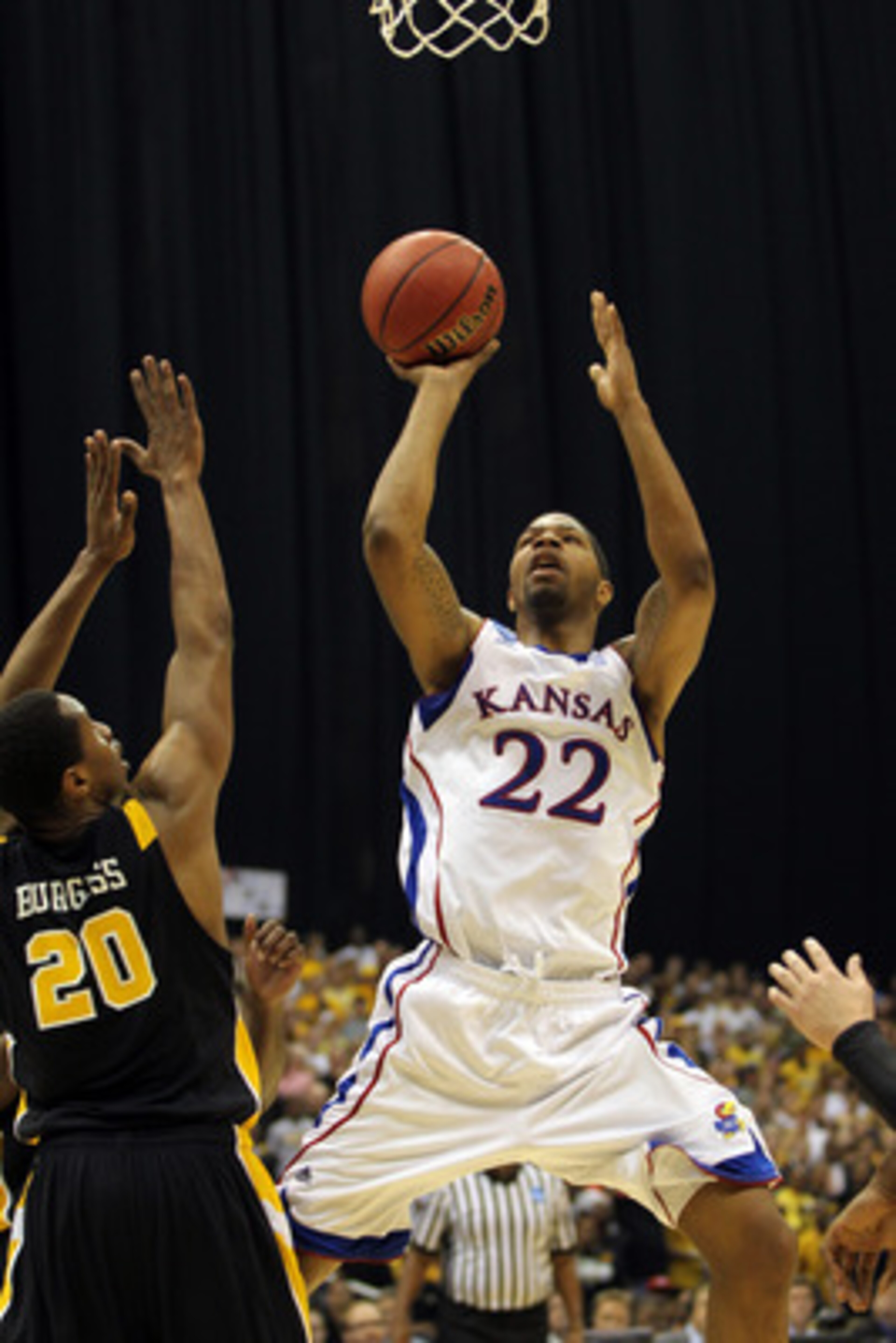 SAN ANTONIO, TX - MARCH 27: Marcus Morris #22 of the Kansas Jayhawks puts up a shot against Bradford Burgess #20 of the Virginia Commonwealth Rams during the southwest regional final of the 2011 NCAA men's basketball tournament at the Alamodome on March SAN ANTONIO, TX - MARCH 27: Marcus Morris #22 of the Kansas Jayhawks puts up a shot against Bradford Burgess #20 of the Virginia Commonwealth Rams during the southwest regional final of the 2011 NCAA men's basketball tournament at the Alamodome on March