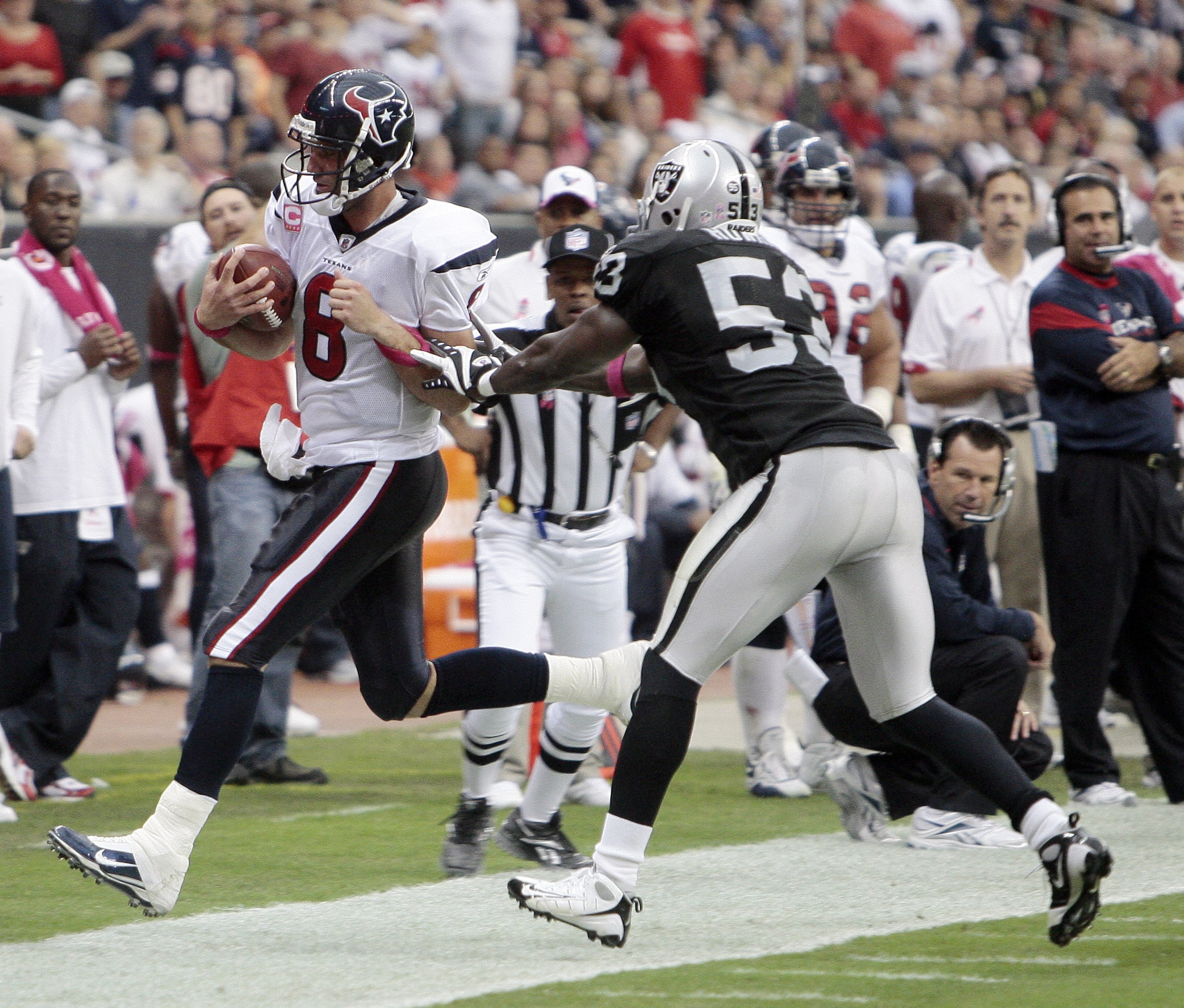 HOUSTON - OCTOBER 04:  Quarterback Matt Schaub #8 of the Houston Texans is pushed out of bounds by linebacker Thomas Howard #53 of the Oakland Raiders at Reliant Stadium on October 4, 2009 in Houston, Texas.  (Photo by Bob Levey/Getty Images)