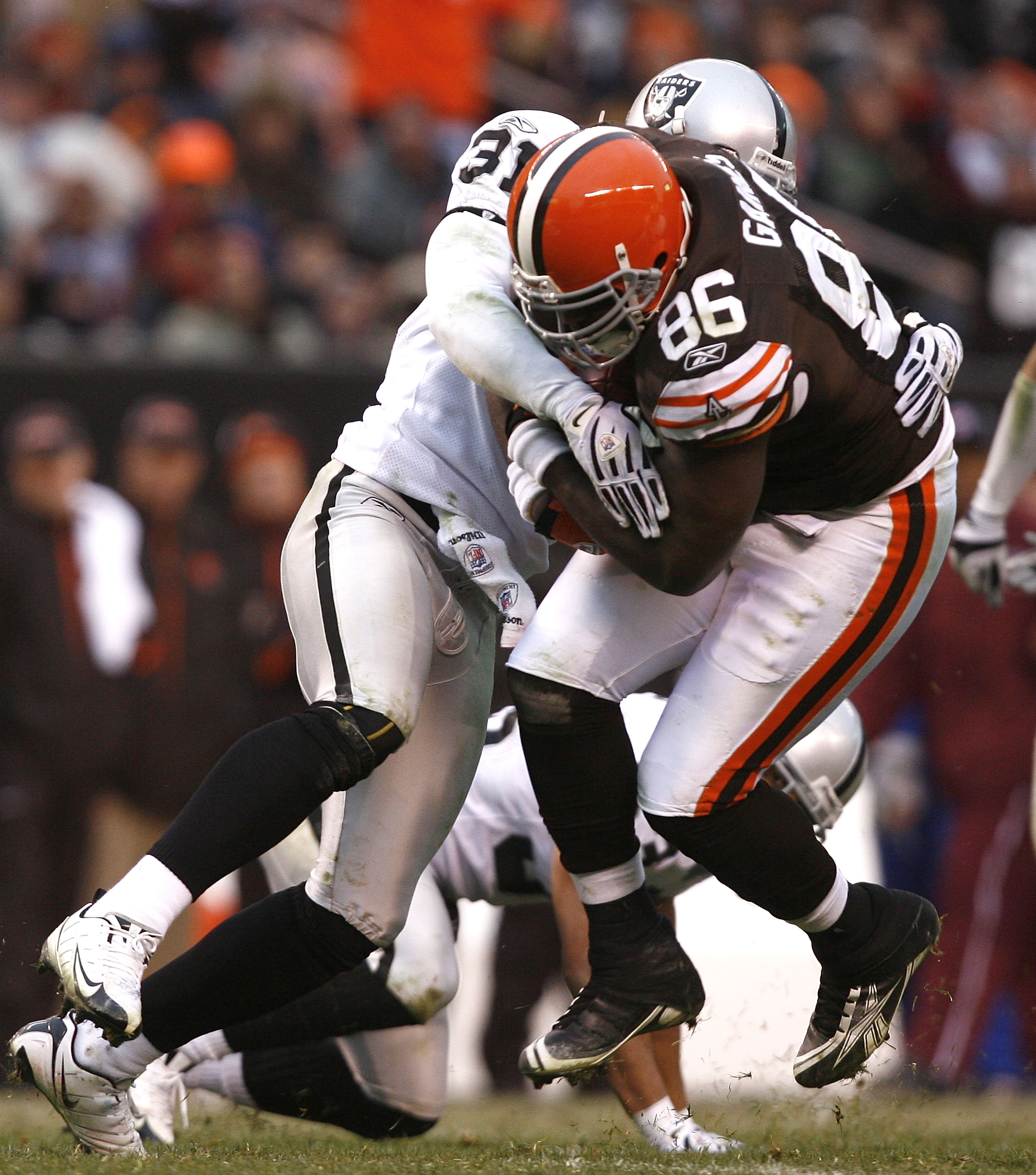 CLEVELAND - DECEMBER 27:  Michael Gaines #86 of the Cleveland Browns is hit by Hiram Eugene #31 of the Oakland Raiders at Cleveland Browns Stadium on December 27, 2009 in Cleveland, Ohio.  (Photo by Matt Sullivan/Getty Images)