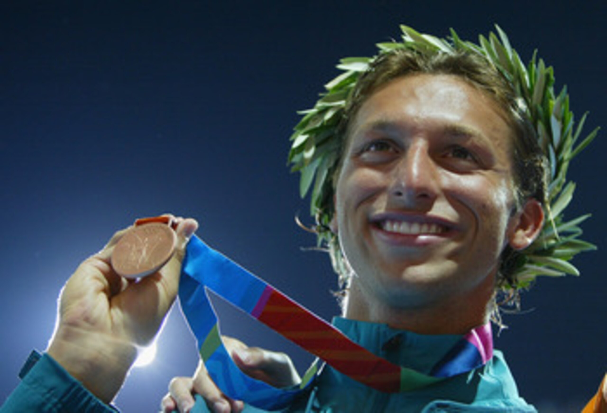 ATHENS - AUGUST 18: Bronze medalist Ian Thorpe of Australia celebrate on the podium during the men's swimming 100 metre freestyle event on August 18, 2004 during the Athens 2004 Summer Olympic Games at the Main Pool of the Olympic Sports Complex Aquatic C