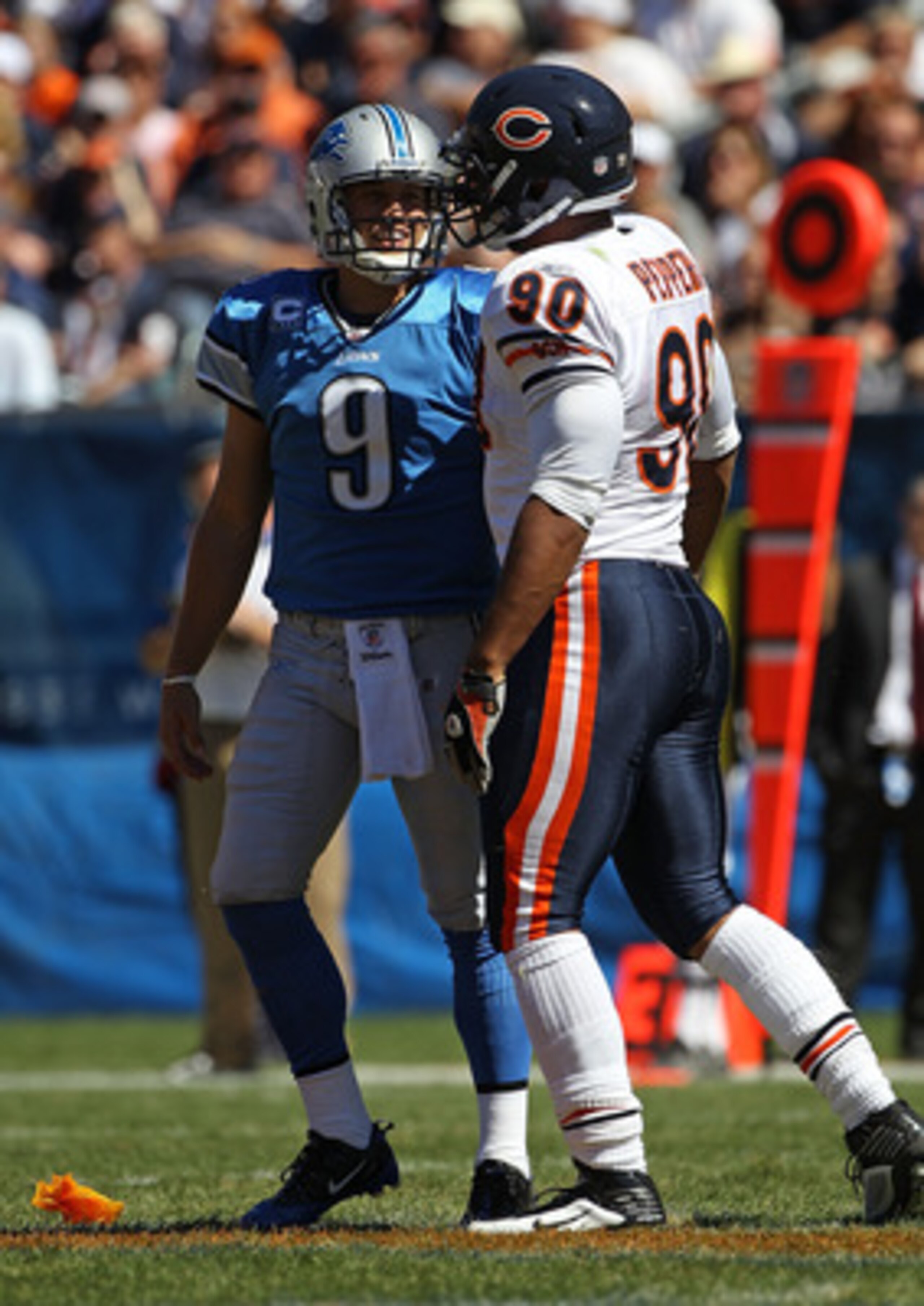 CHICAGO - SEPTEMBER 12: Julius Peppers #90 of the Chicago Bears talks with Matthew Stafford #9 of the Detroit Lions after a late hit in the head earning a penalty for Peppers during the NFL season opening game at Soldier Field on September 12, 2010 in Chi