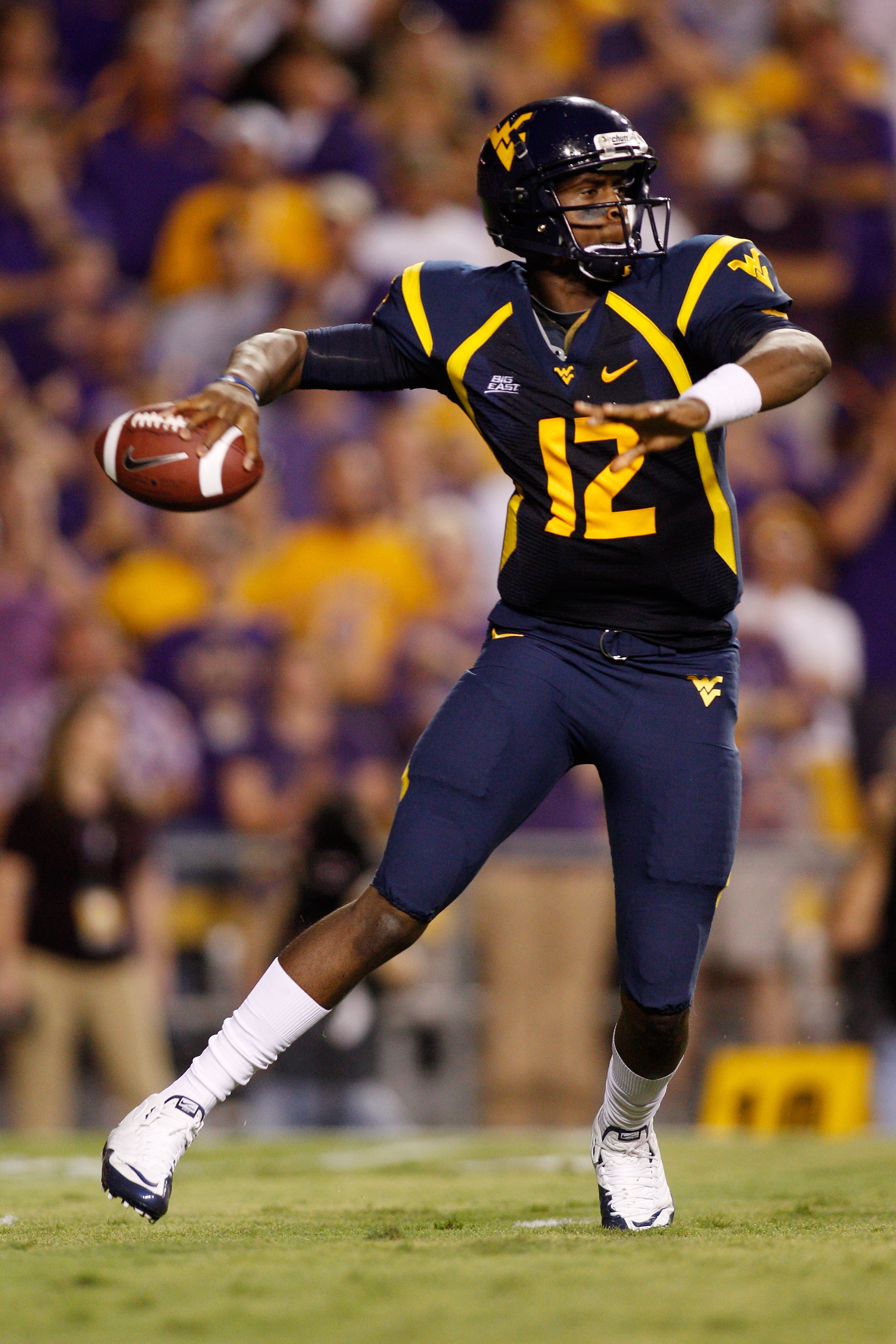 BATON ROUGE, LA - SEPTEMBER 25:  Quarterback Geno Smith #12 of the West Virginia Mountaineers looks to throw a pass against the Louisiana State University Tigers at Tiger Stadium on September 25, 2010 in Baton Rouge, Louisiana.  (Photo by Chris Graythen/G