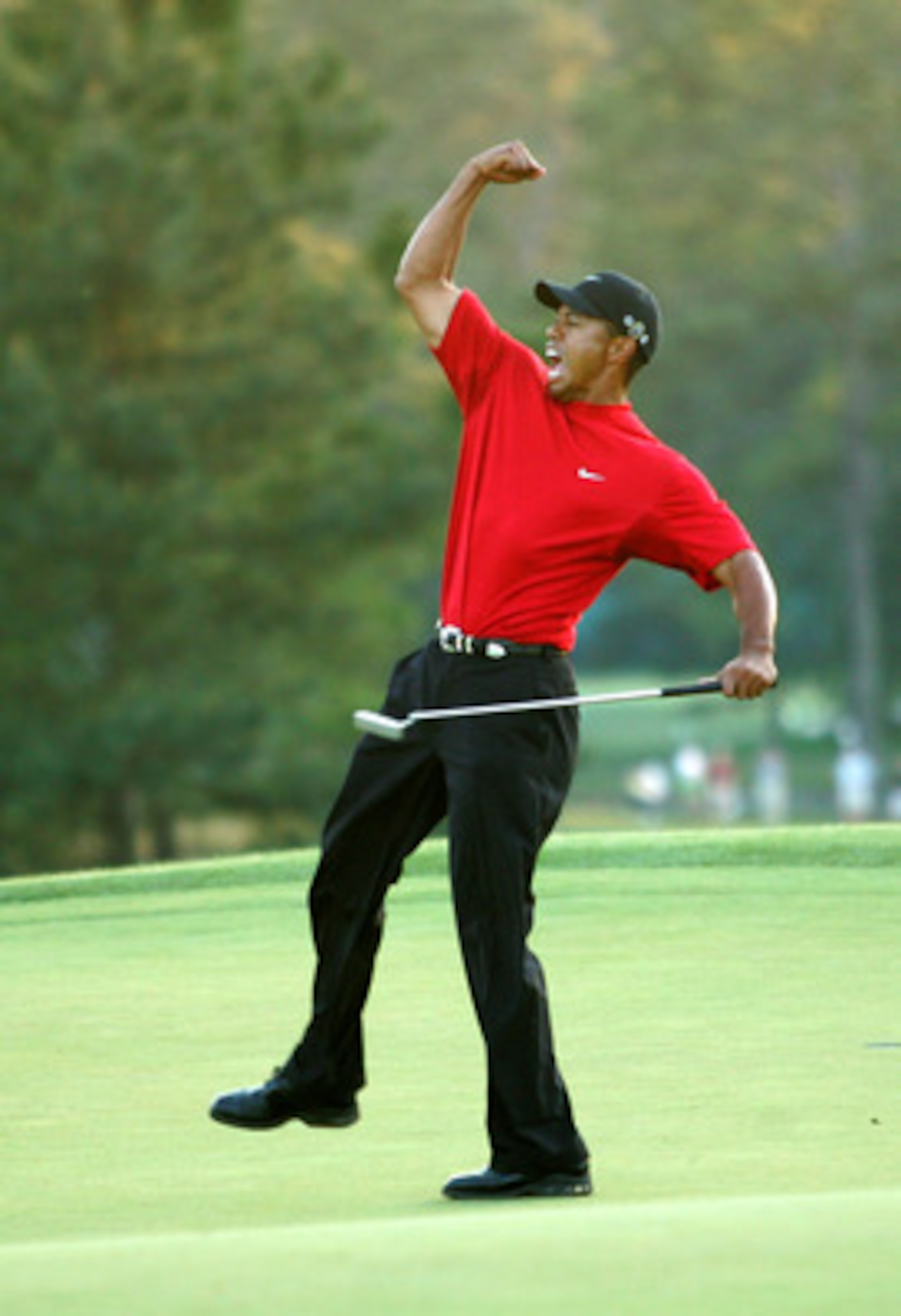 AUGUSTA, GA - APRIL 10:  Tiger Woods celebrates after sinking a putt on the first playoff hole to win the 2005 Masters on April 10, 2005 at Augusta National Golf Course in Augusta, Georgia.  (Photo By Getty Images)