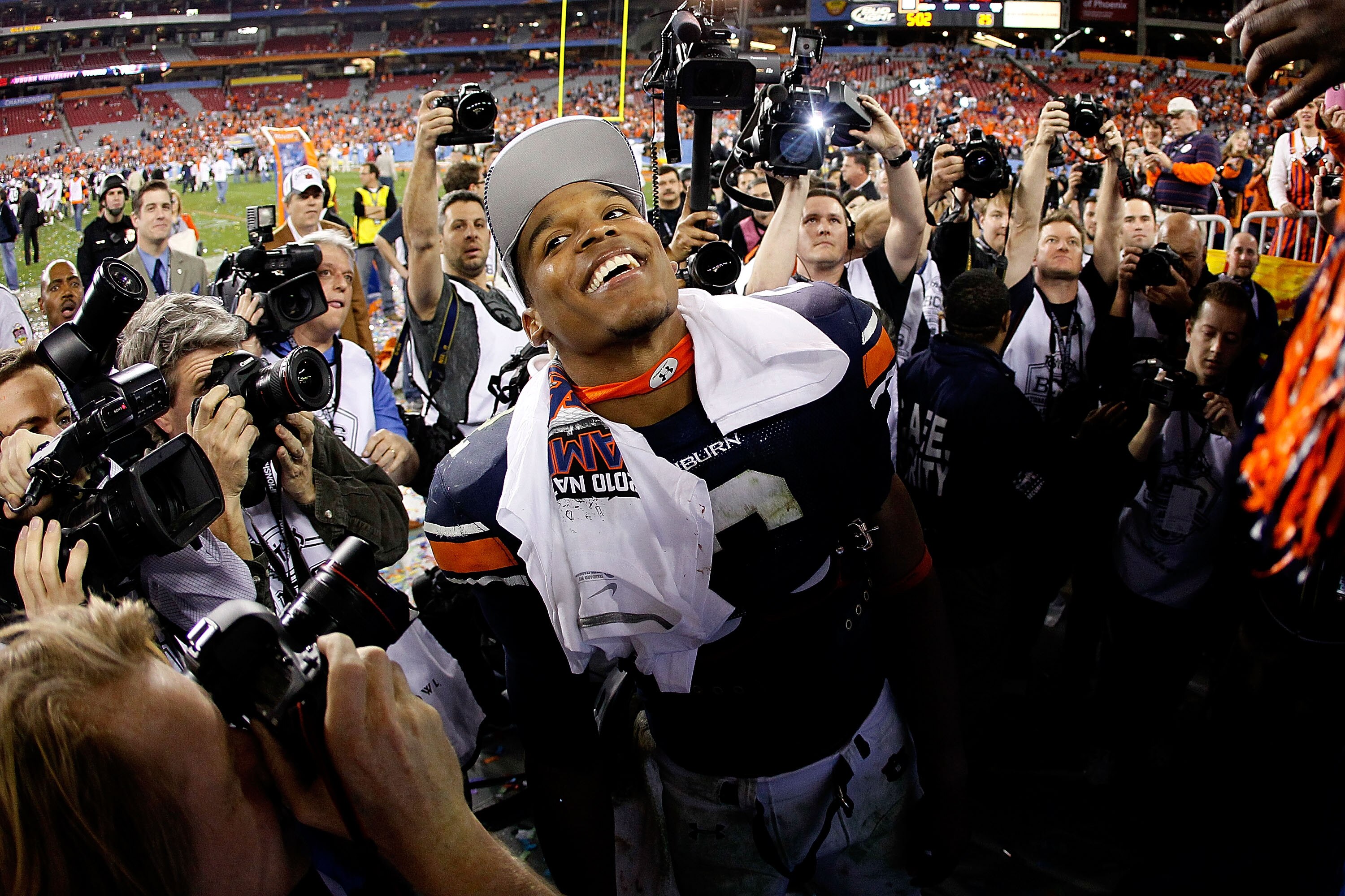 GLENDALE, AZ - JANUARY 10:  Quarterback Cameron Newton #2 of the Auburn Tigers celebrates the Tigers 22-19 victory with the fans after defeating the Oregon Ducks in the Tostitos BCS National Championship Game at University of Phoenix Stadium on January 10