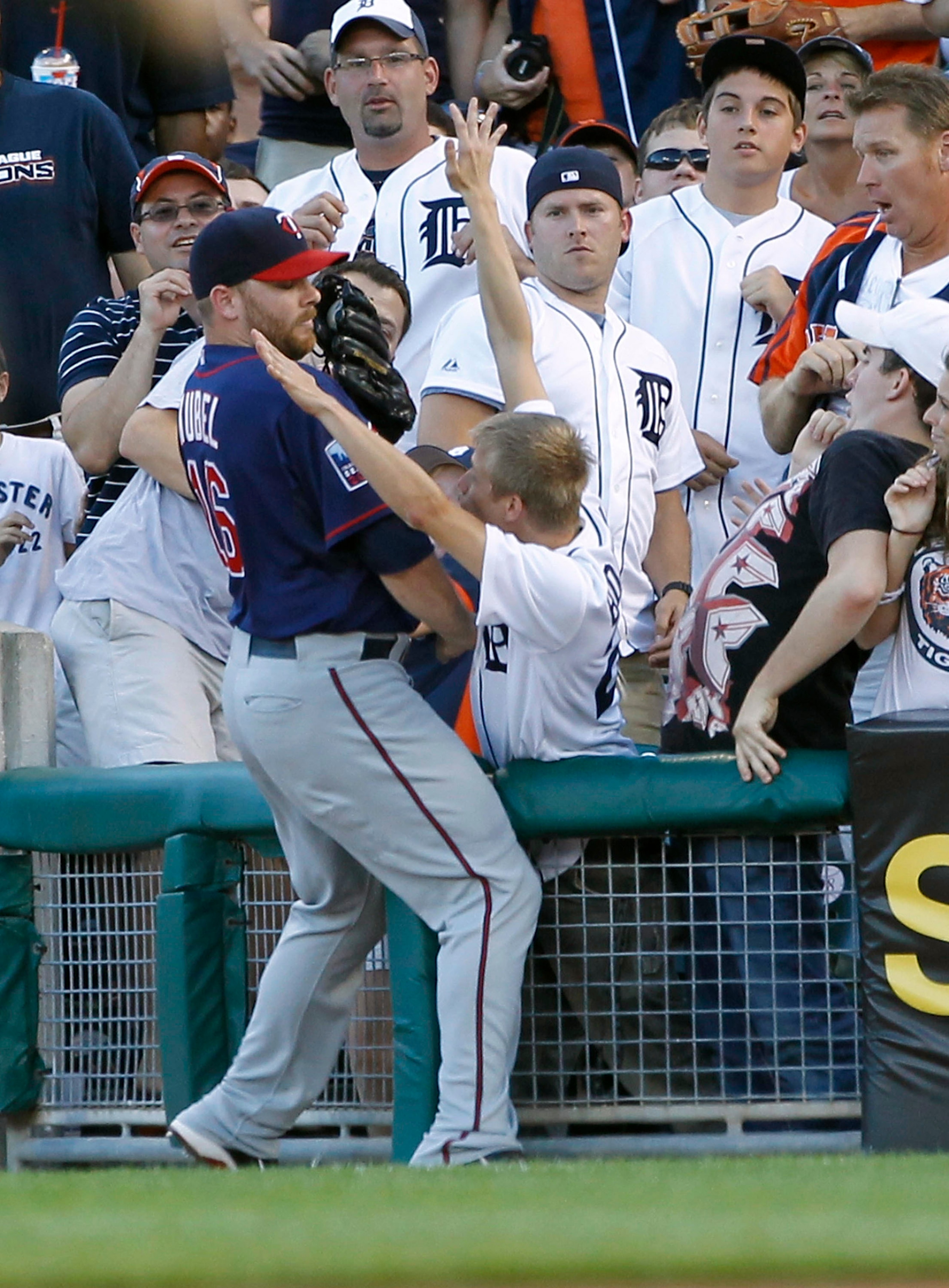 DETROIT - JULY 09:  Jason Kubel #16 of the Minnesota Twins fights with a Tigers fan over a foul ball during the third inning during the game against the Detroit Tigers on July 9, 2010 at Comerica Park in Detroit, Michigan. The Tigers defeated the Twins 7-