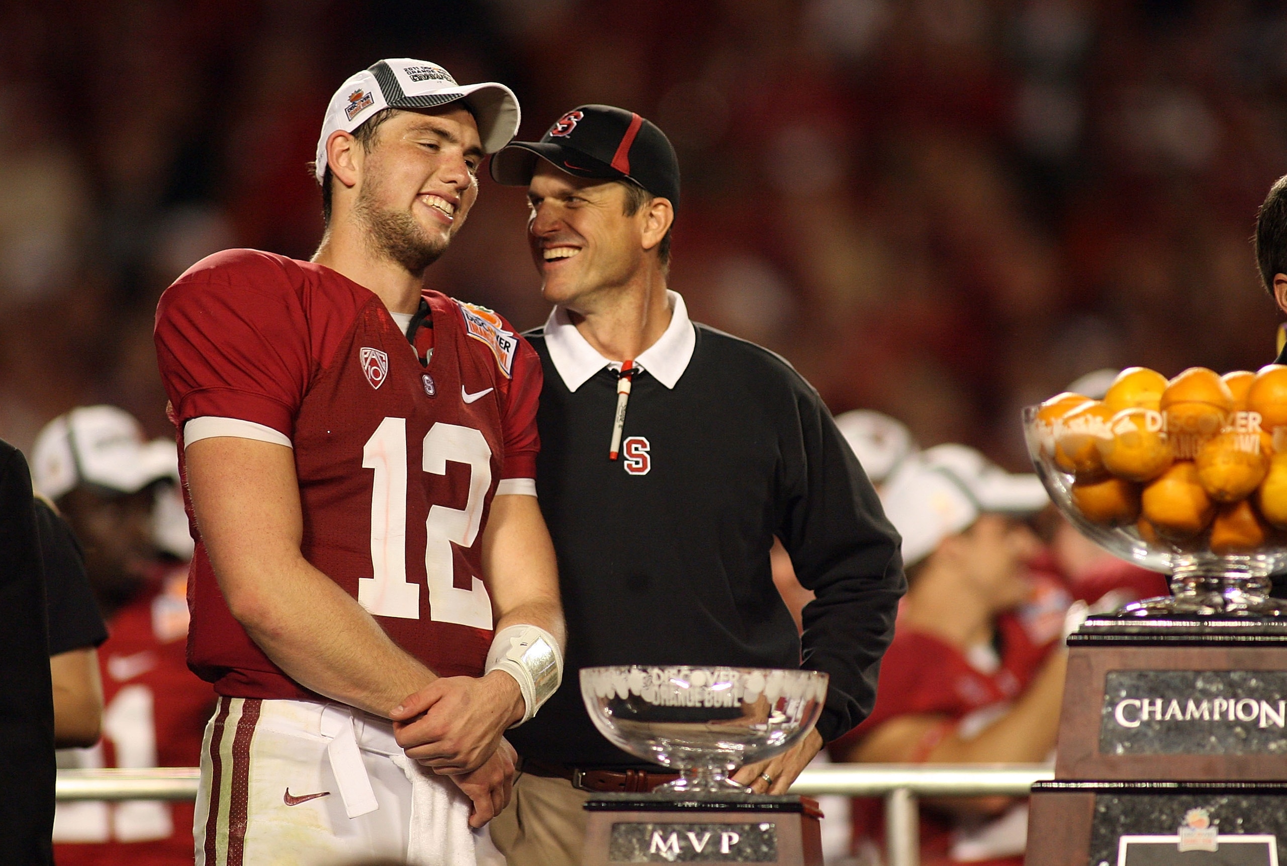 MIAMI, FL - JANUARY 03: (L-R) Quarterback Andrew Luck #12 and head coach Jim Harbaugh of the Stanford Cardinal celebrate with the trophy on stage after Stanford won 40-12 against the Virginia Tech Hokies during the 2011 Discover Orange Bowl at Sun Life St MIAMI, FL - JANUARY 03: (L-R) Quarterback Andrew Luck #12 and head coach Jim Harbaugh of the Stanford Cardinal celebrate with the trophy on stage after Stanford won 40-12 against the Virginia Tech Hokies during the 2011 Discover Orange Bowl at Sun Life St