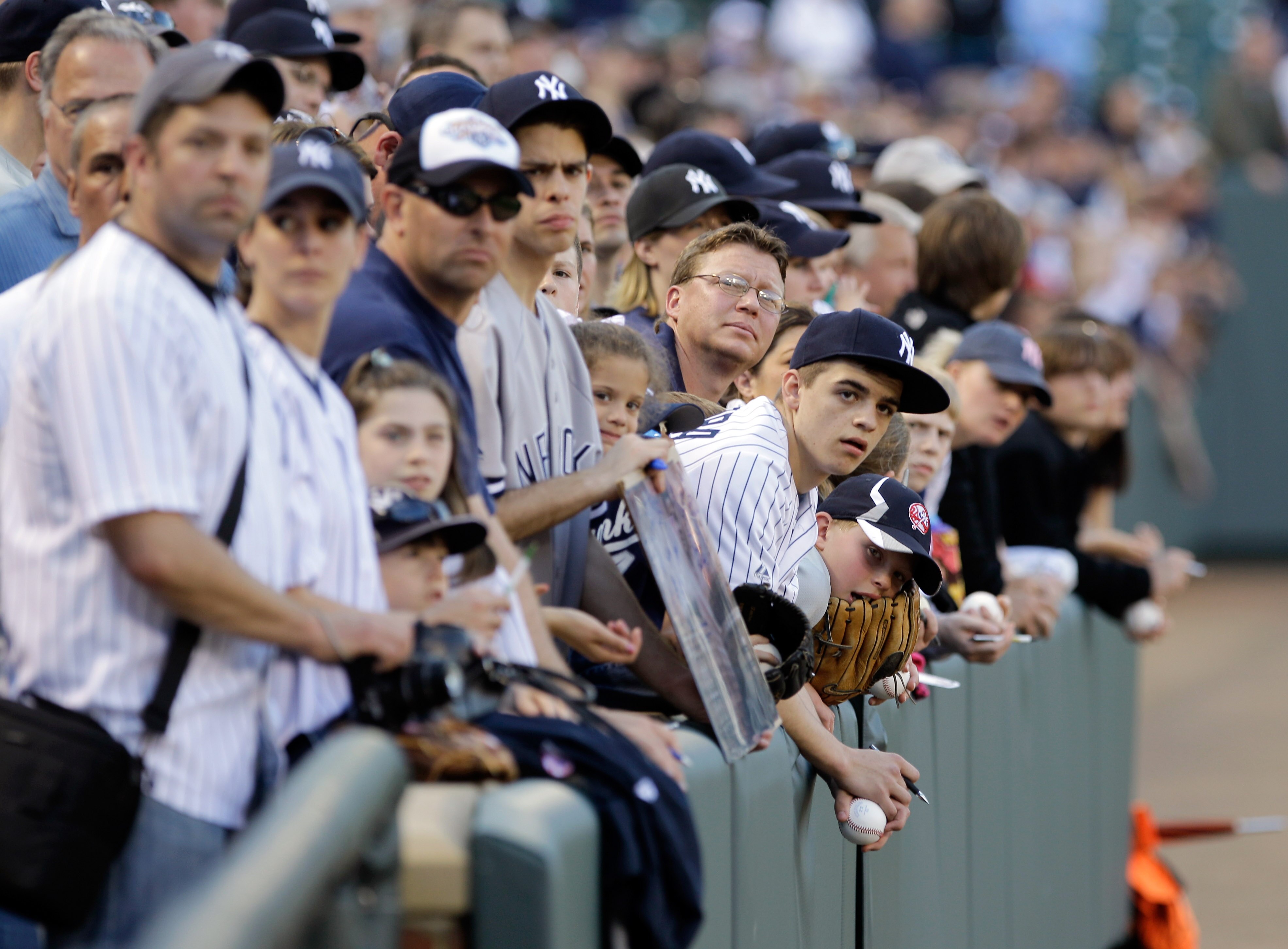 BALTIMORE, MD - APRIL 23:  New York Yankees fans try and get autographs prior to the start of the New York Yankees and Baltimore Orioles game at Oriole Park at Camden Yards on April 23, 2011 in Baltimore, Maryland.  (Photo by Rob Carr/Getty Images)