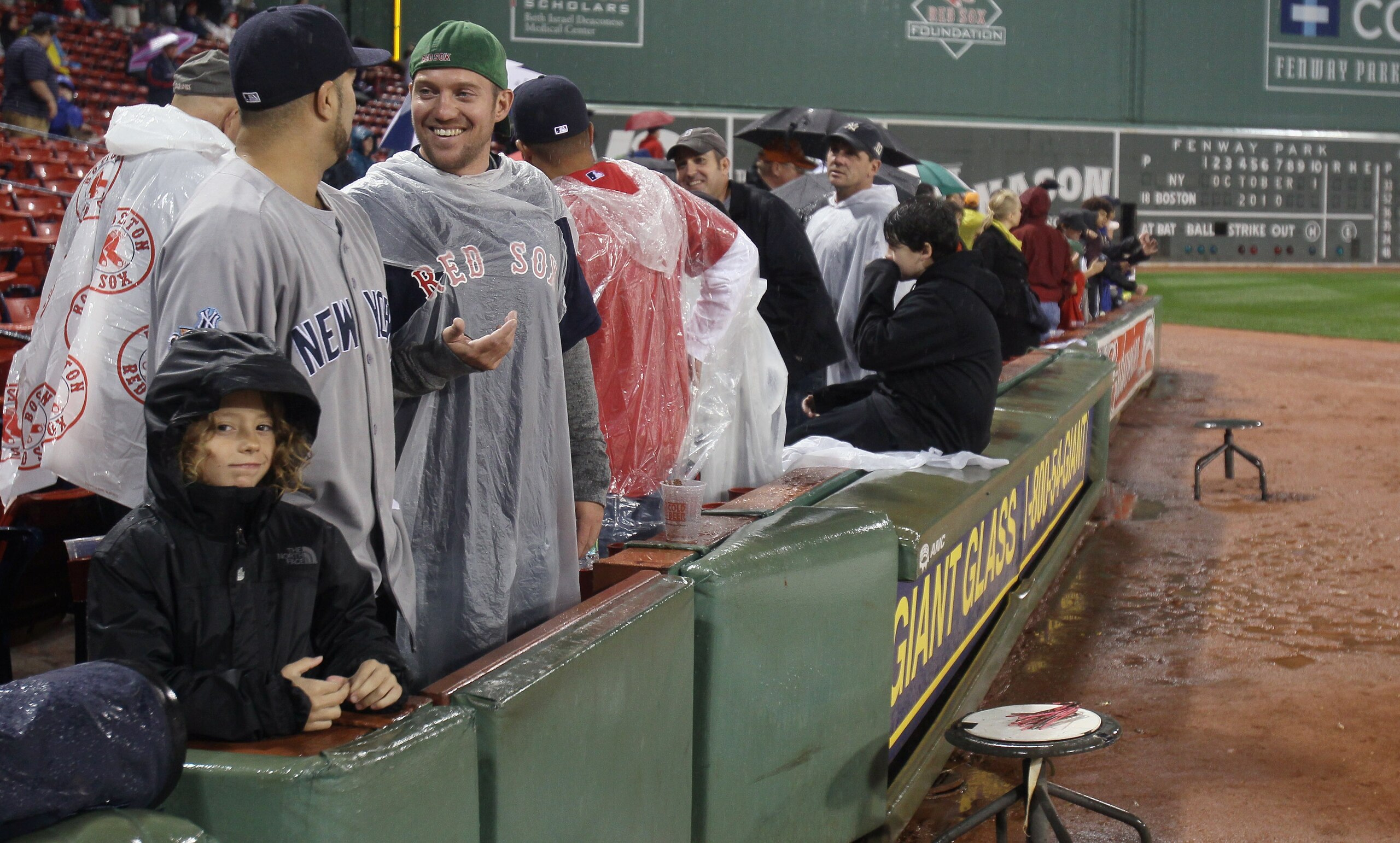 BOSTON - OCTOBER 01:  Fans patiently wait to hear that game between Boston Red Sox and the New York Yankees is postponed until tomorrow due to rain on October 1, 2010 at Fenway Park in Boston, Massachusetts.  (Photo by Elsa/Getty Images)