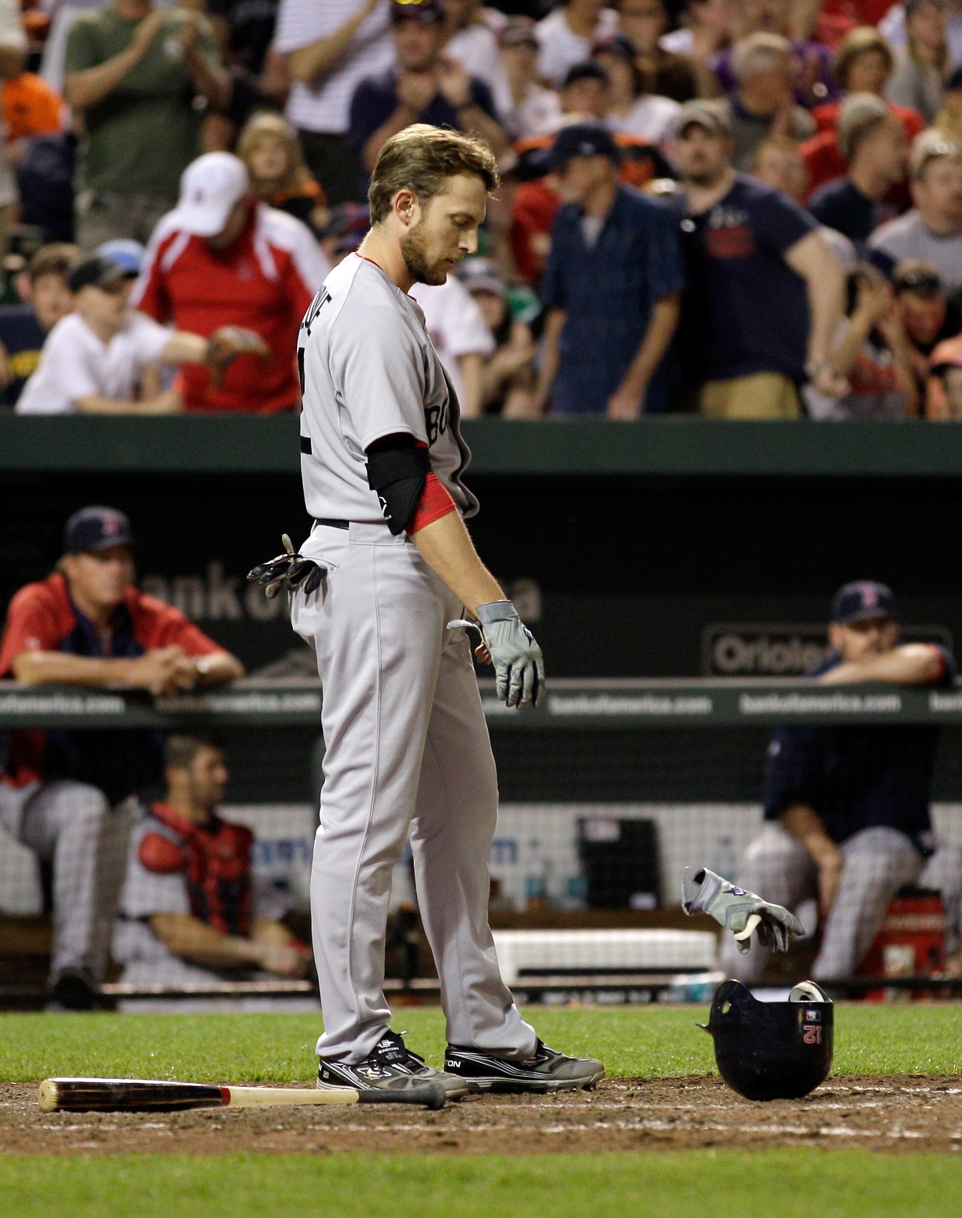 BALTIMORE, MD - APRIL 26:  Jed Lowrie #12 of the Boston Red Sox reacts after striking out to end the eighth inning during a 4-1 loss to the Baltimore Oriolesat Oriole Park at Camden Yards on April 26, 2011 in Baltimore, Maryland.  (Photo by Rob Carr/Getty